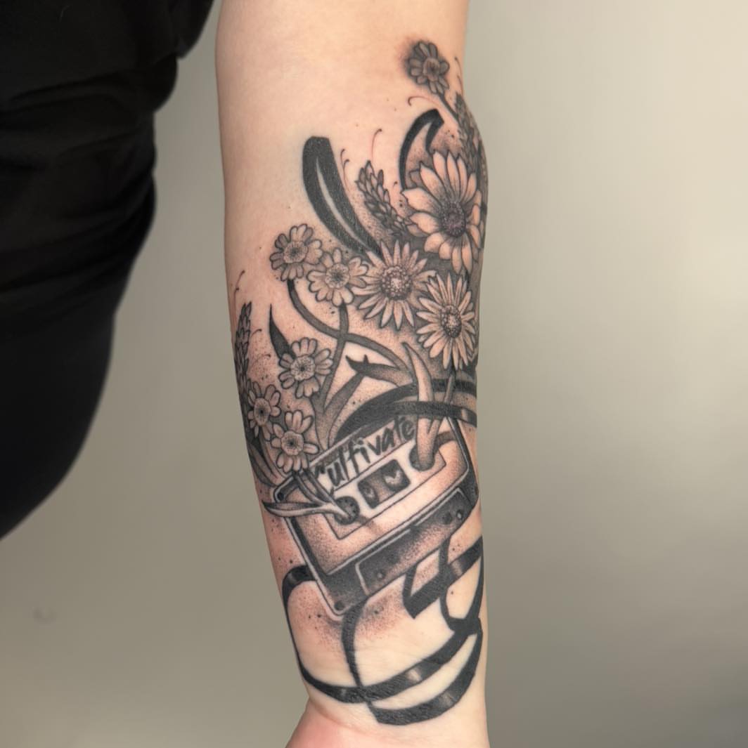 Flower bouquet with cassette tape dotwork tattoo on the forearm by Tattoos by Aeron Herald Maurbjorn, Sioux
