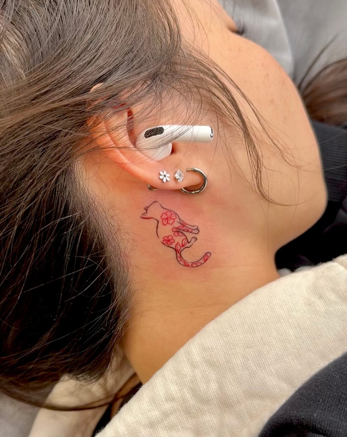 Bird and flowers fine line tattoo on the neck by Ethan