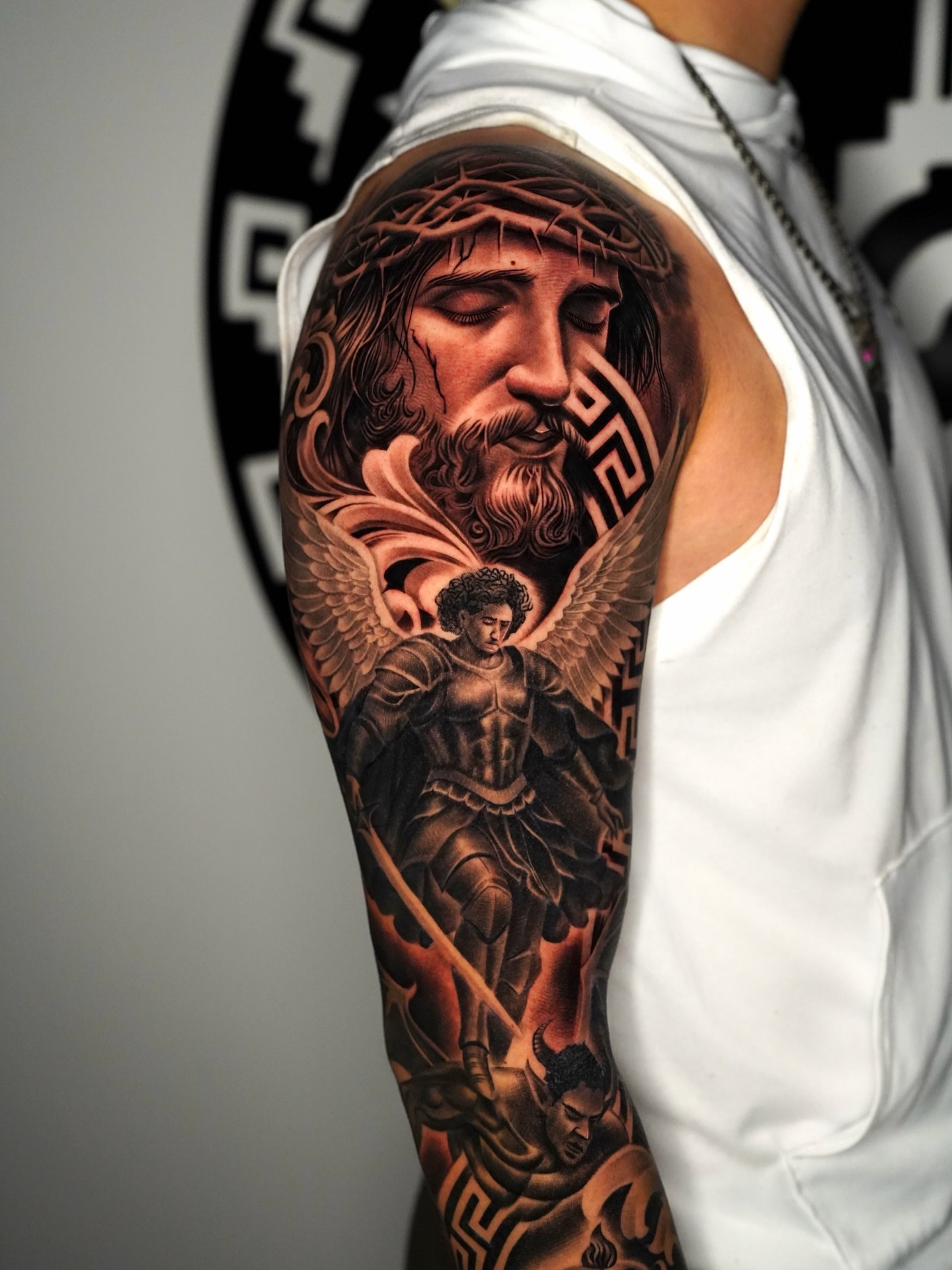 Religious figure realism tattoo on the upper arm by Salvador Saenz Jr, Dallas, Texas
