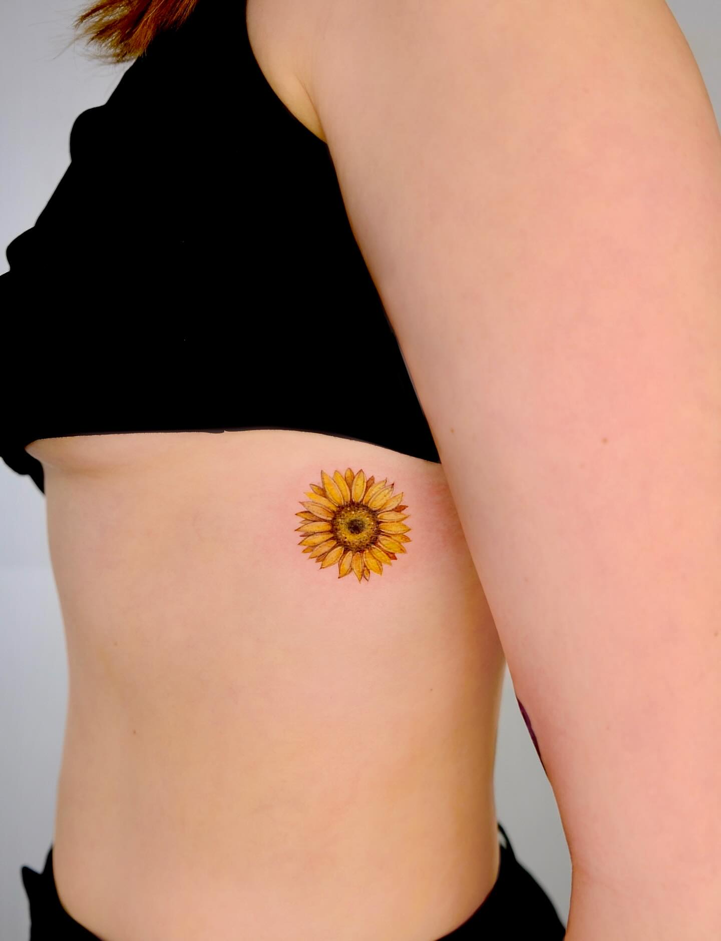 Sunflower dotwork tattoo on the ribs by Thin line and color TATTOO.