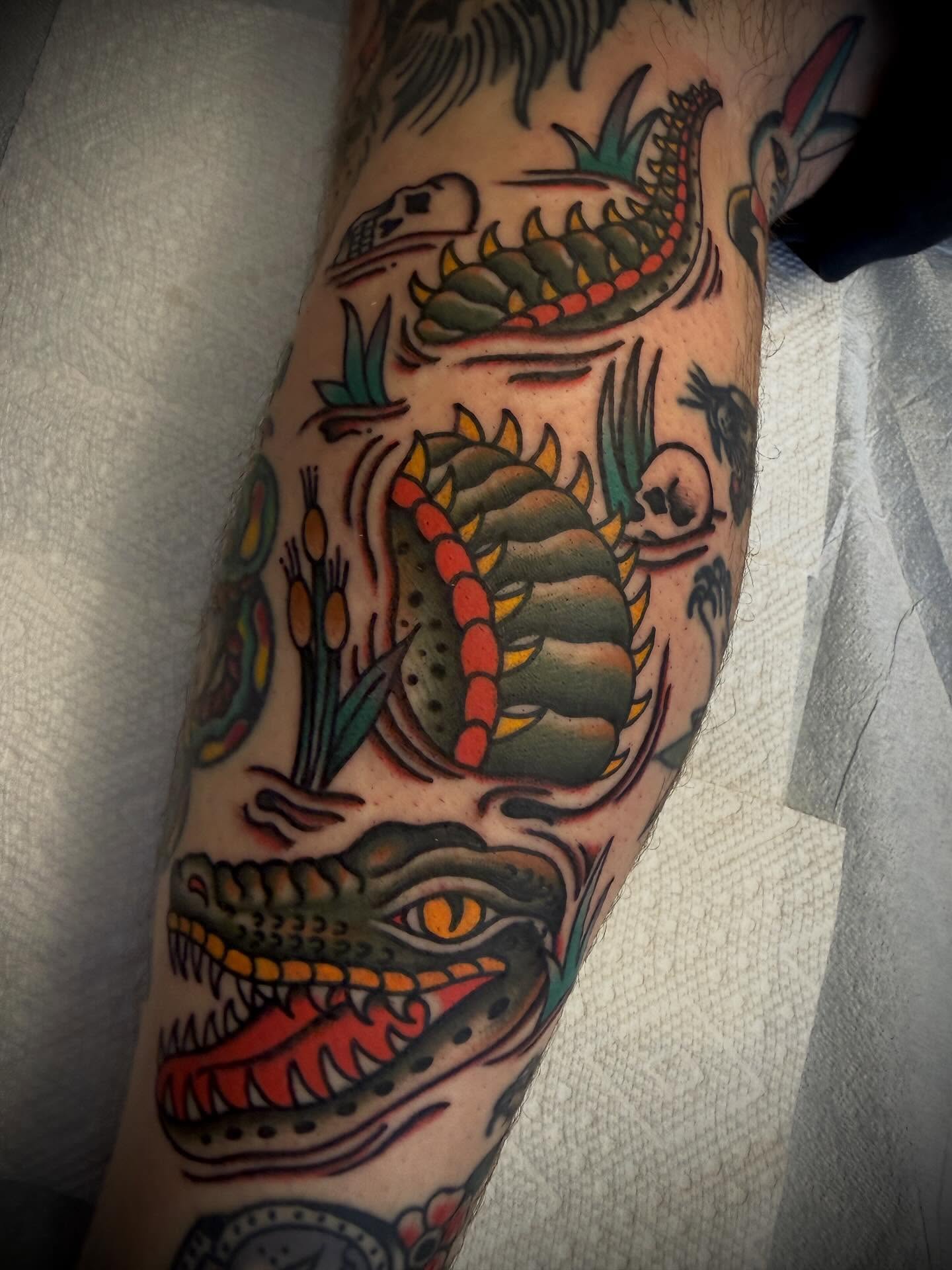 Serpent and skull American traditional tattoo on the forearm by Andrew Slater