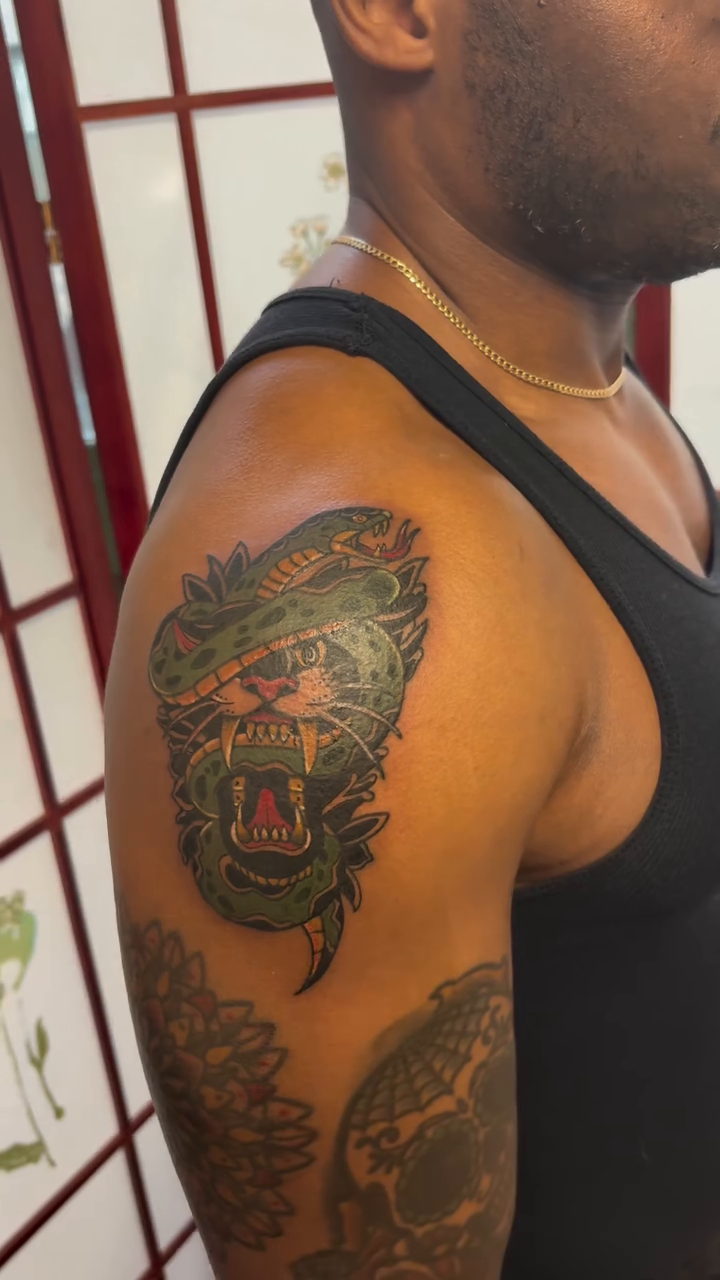 Gorilla and snake realism tattoo on the upper arm by CJ