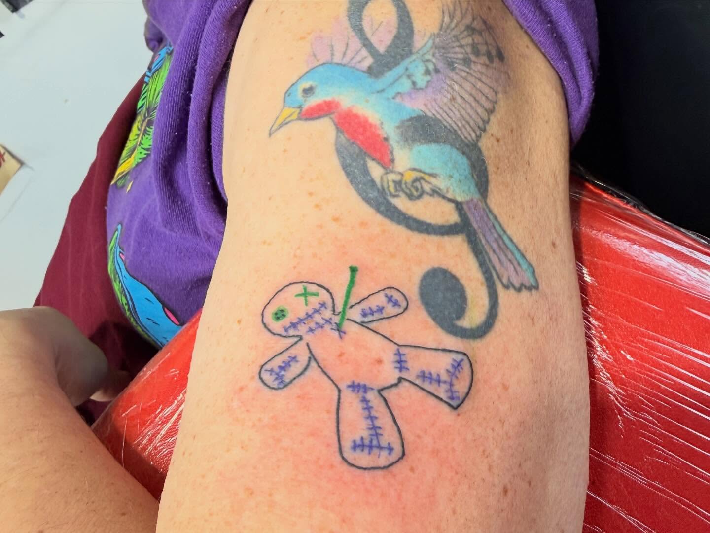 Bird and teddy bear American traditional tattoo on the forearm by Jones Eric