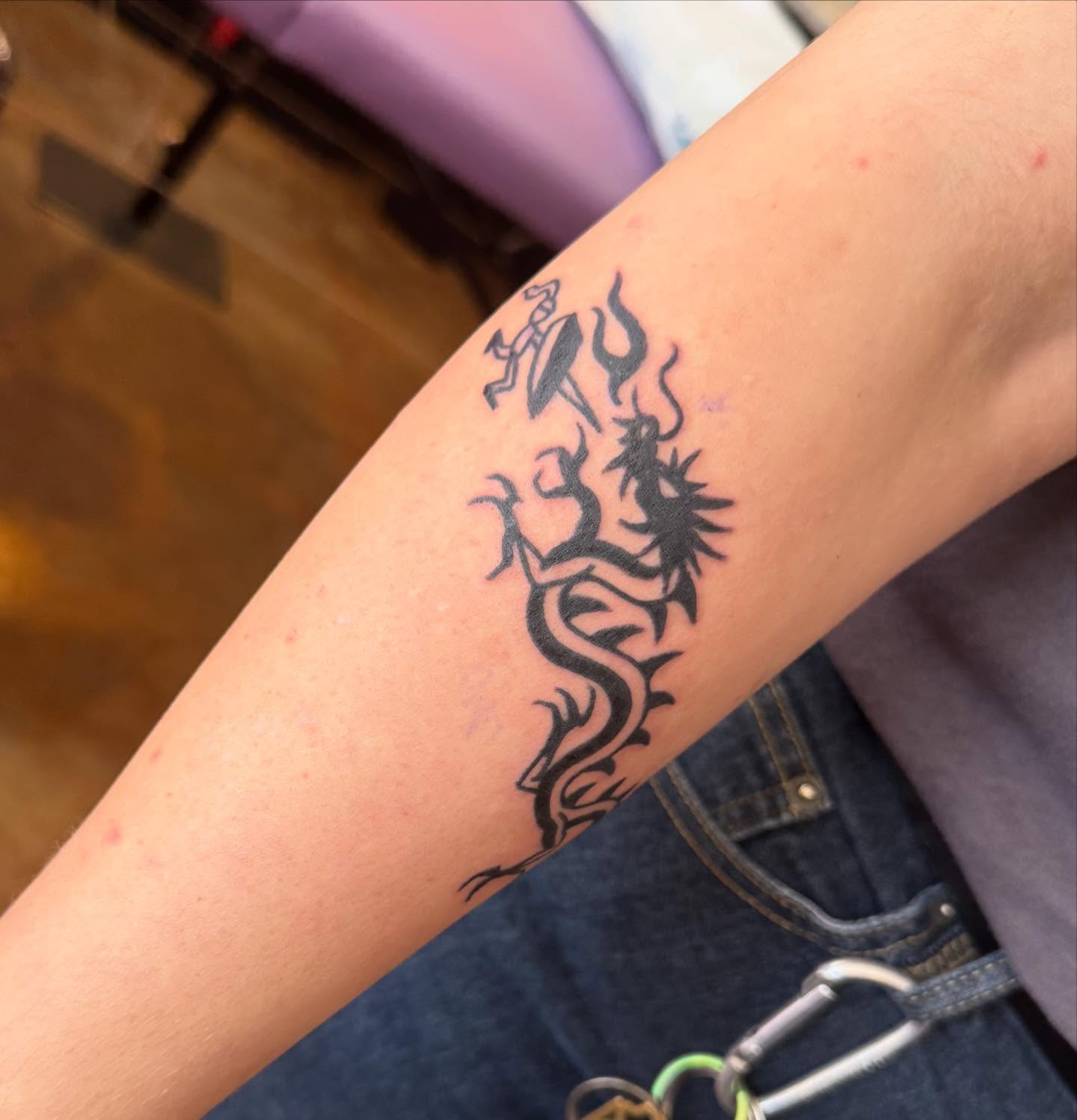 Flame and dragon tribal tattoo on the forearm by Makayla Dupre