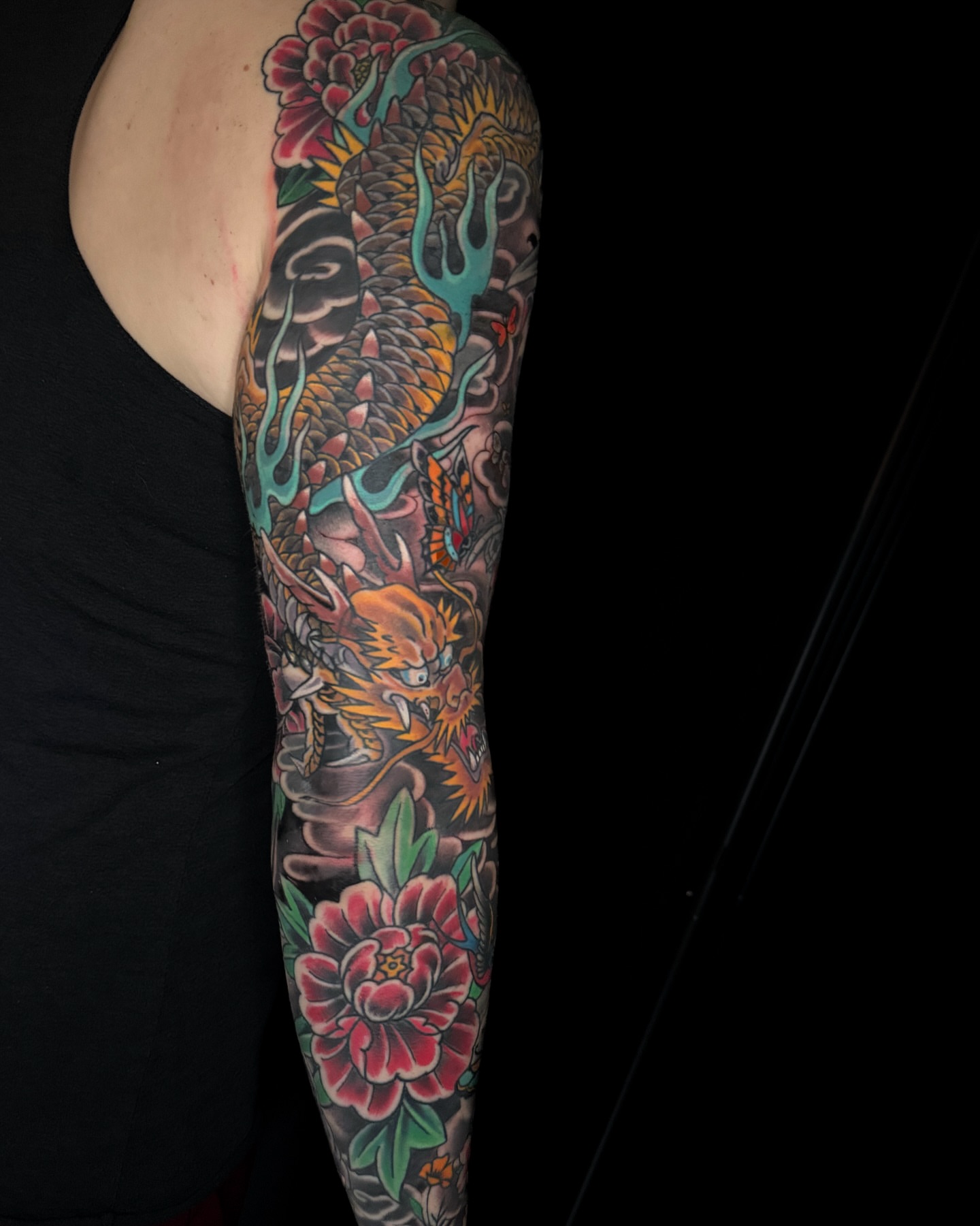 Dragon and peony japanese irezumi tattoo on the forearm by Chris Cockrill