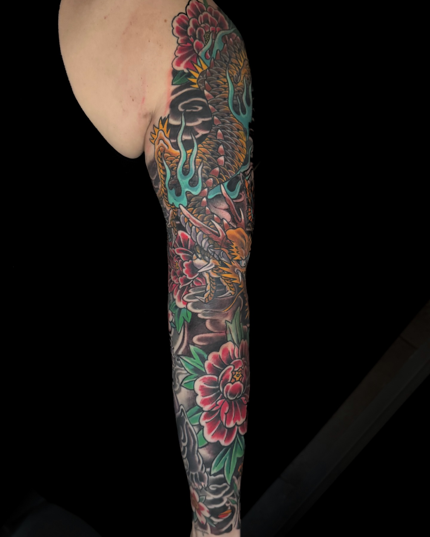 Dragon and peonies japanese irezumi tattoo on the forearm by Chris Cockrill