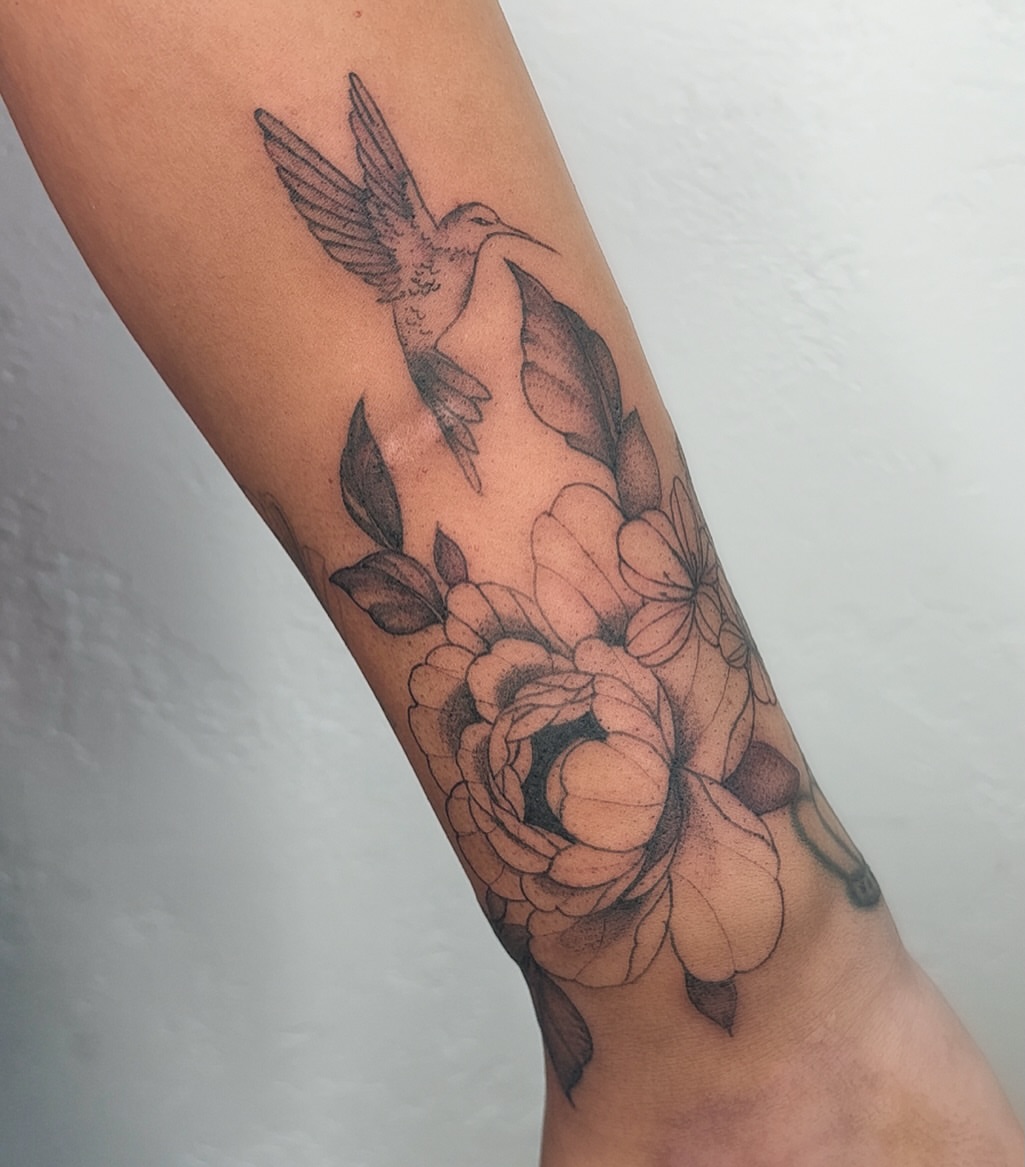Hummingbird and flowers black and grey tattoo on the forearm by ❤️‍🔥 Abigail Chambers ❤️‍🔥