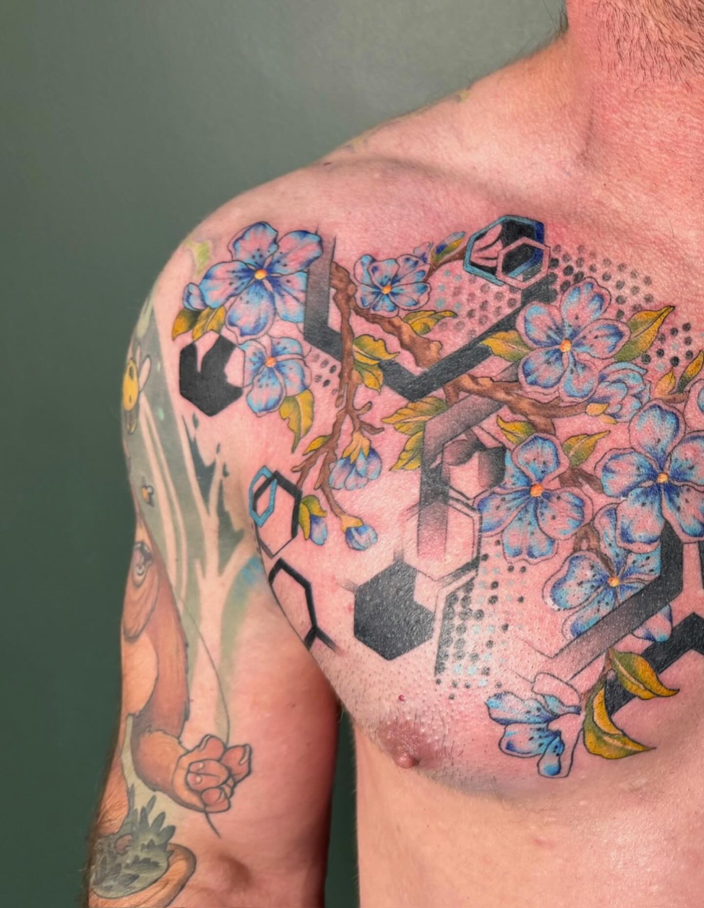 Cherry blossoms and geometric shapes dotwork tattoo on the shoulder by Sarah Margaret