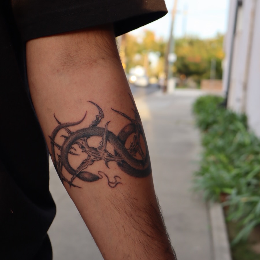 Skull and thorns black and grey tattoo on the forearm by Ladyjutsu