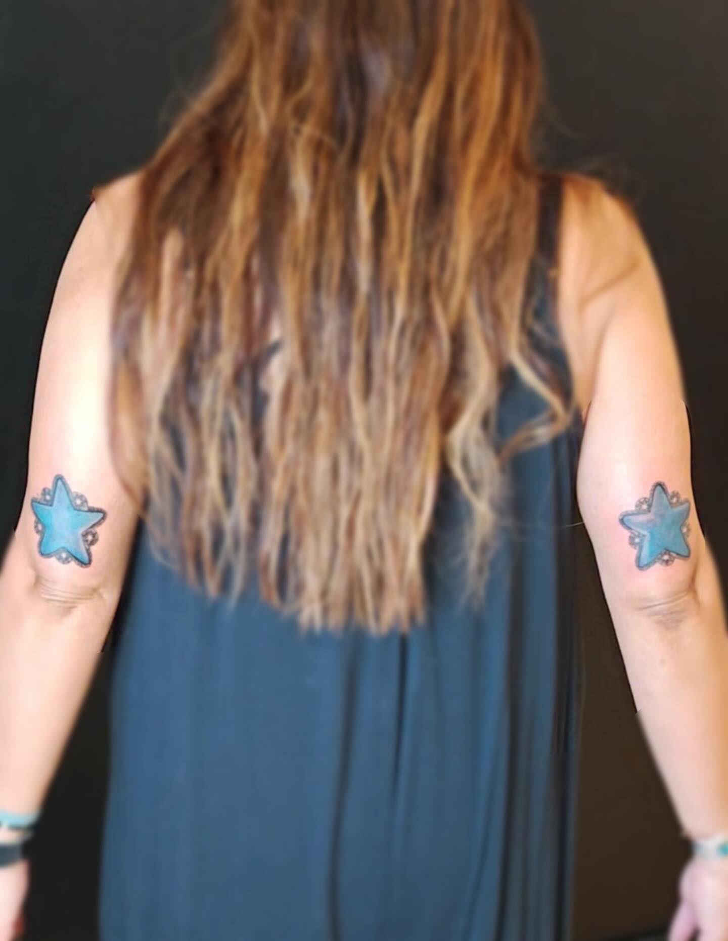 Star geometric tattoo on the upper arm by Sebastiana
