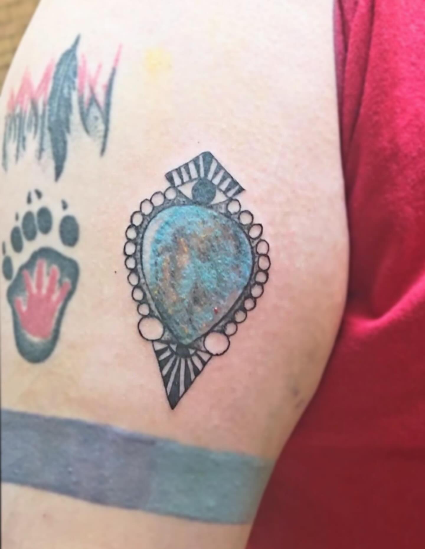 Gemstone pendant geometric tattoo on the forearm by Sebastiana