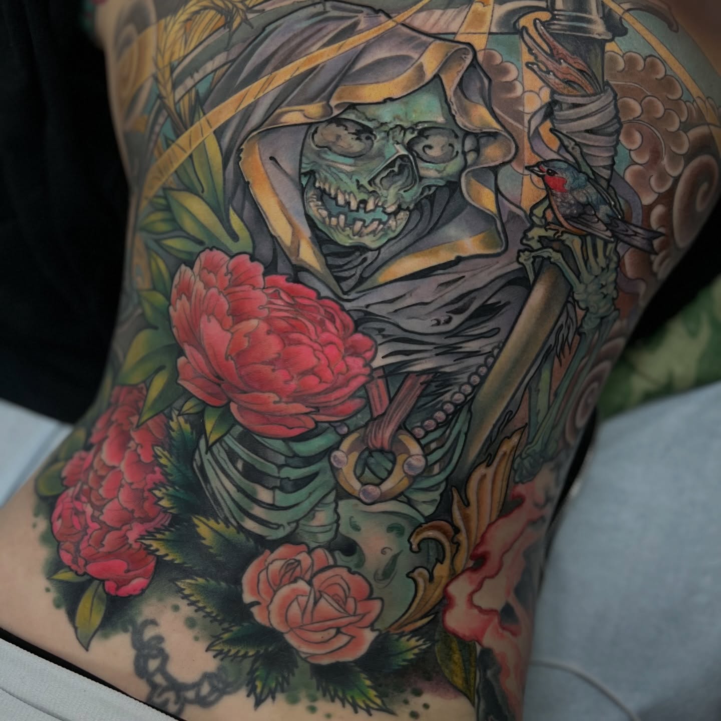Grim reaper with roses American traditional tattoo on the thigh by Fredd Chino