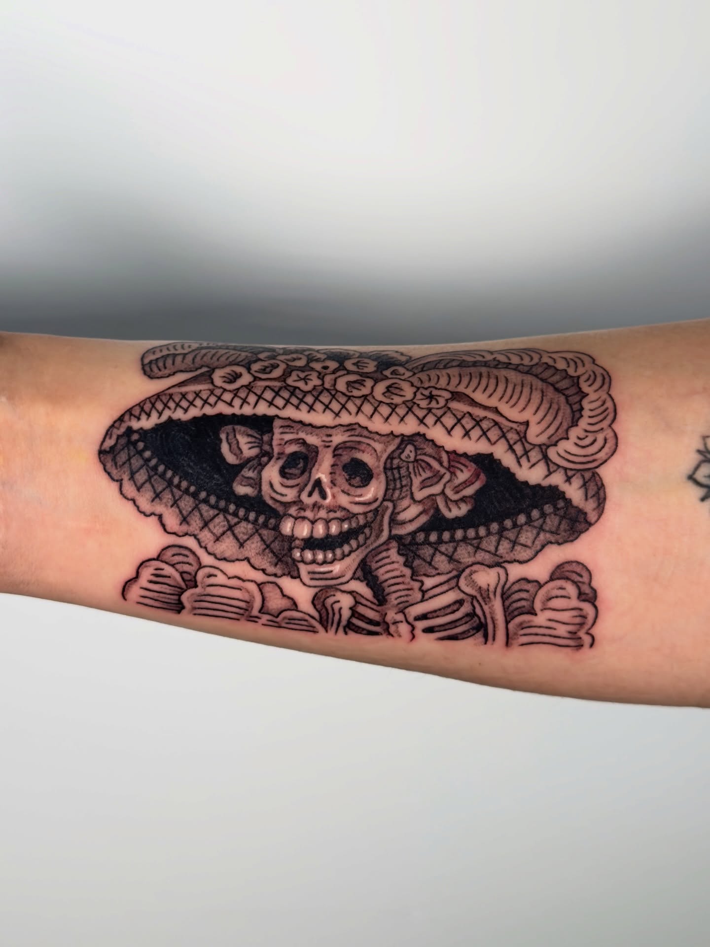 Skull wearing sombrero Chicano tattoo on the forearm by Diana