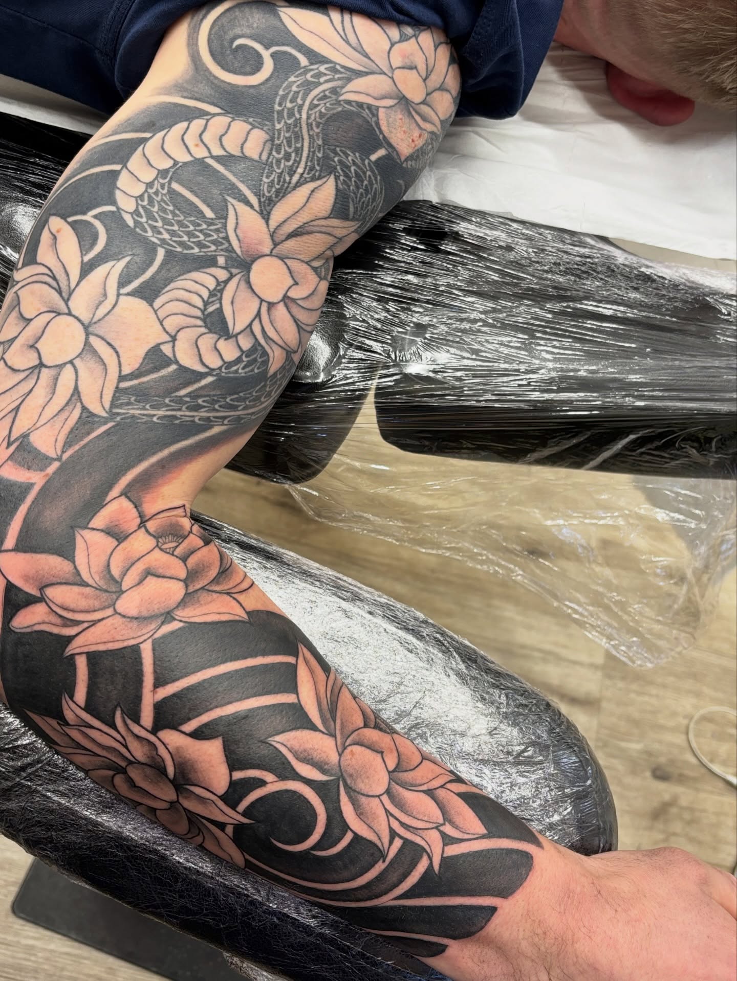 Snake and lotus American traditional tattoo on the forearm by Ruth Ormsby-Ashworth