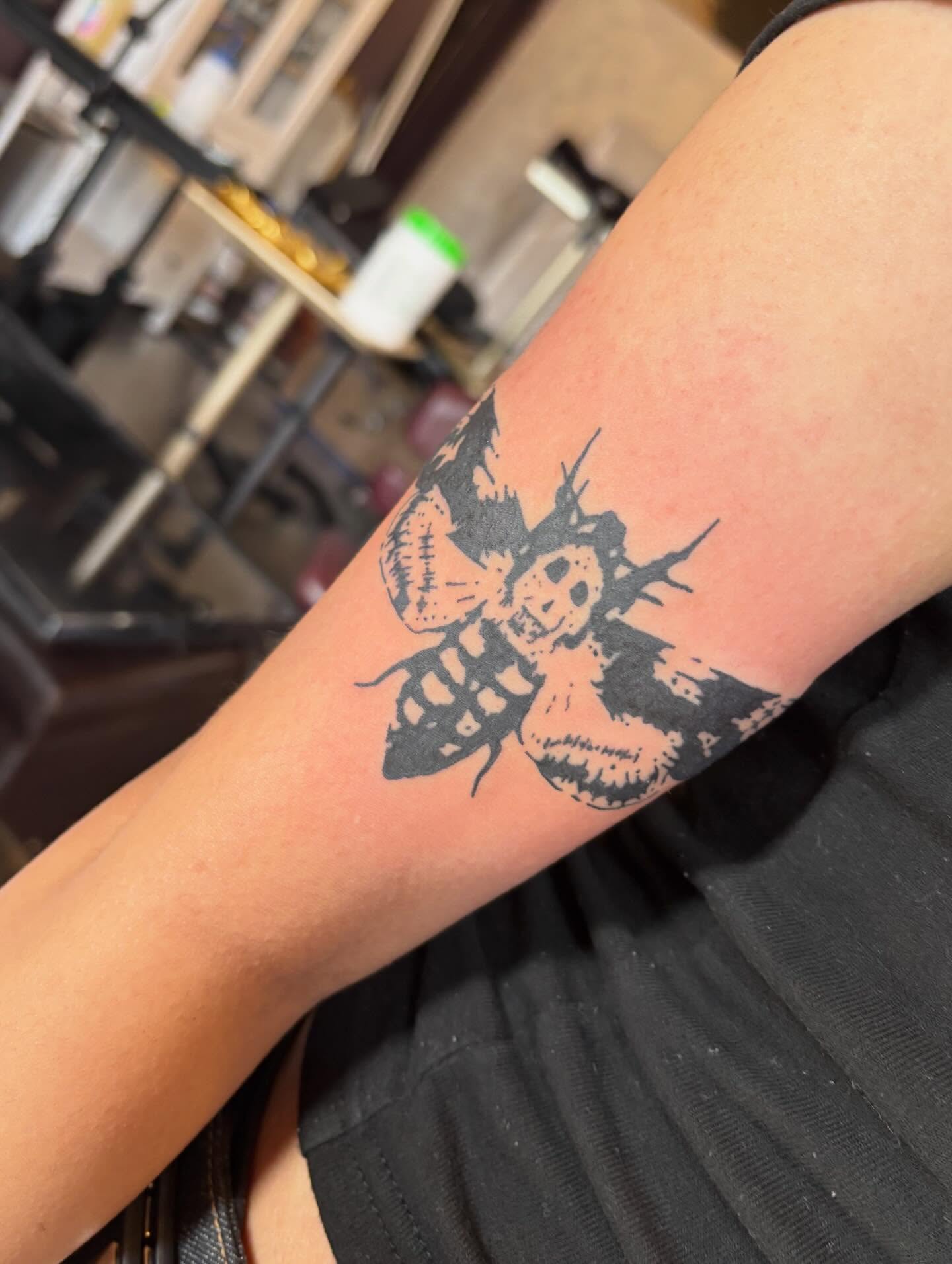 Bee black and grey tattoo on the forearm by Turner