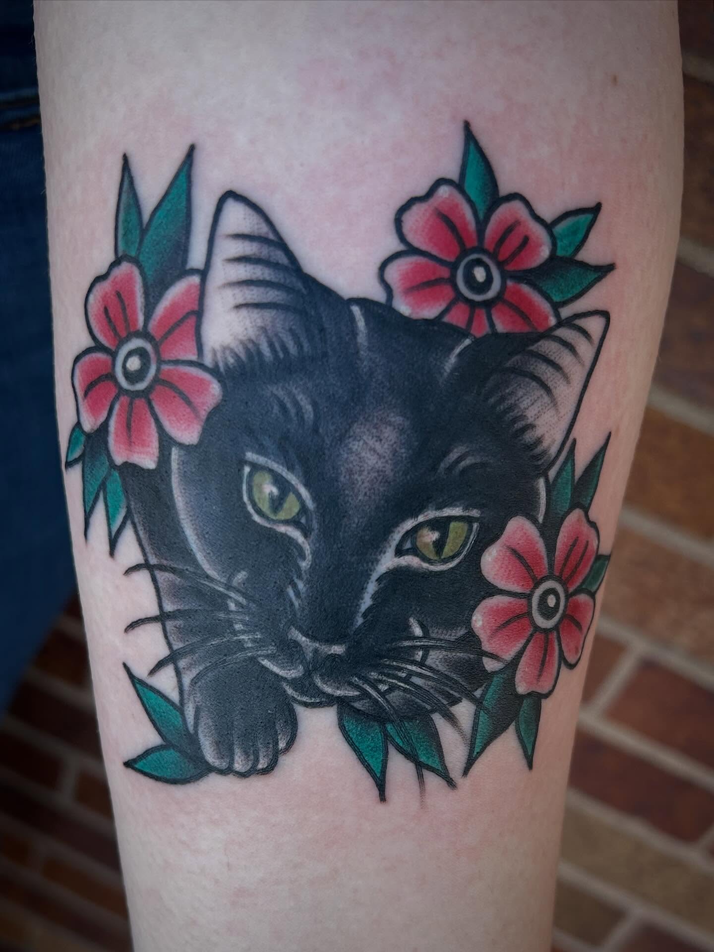 Black cat with flowers American traditional tattoo on the forearm by Morgan Hazer Tattoos, Cedar Rapids, Iowa