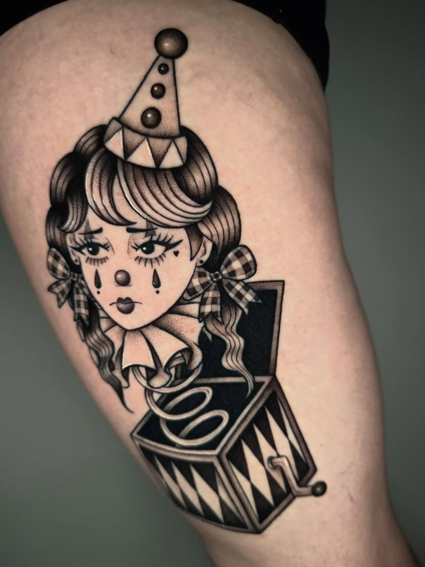 Clown girl American traditional tattoo on the thigh by kelsey hackett