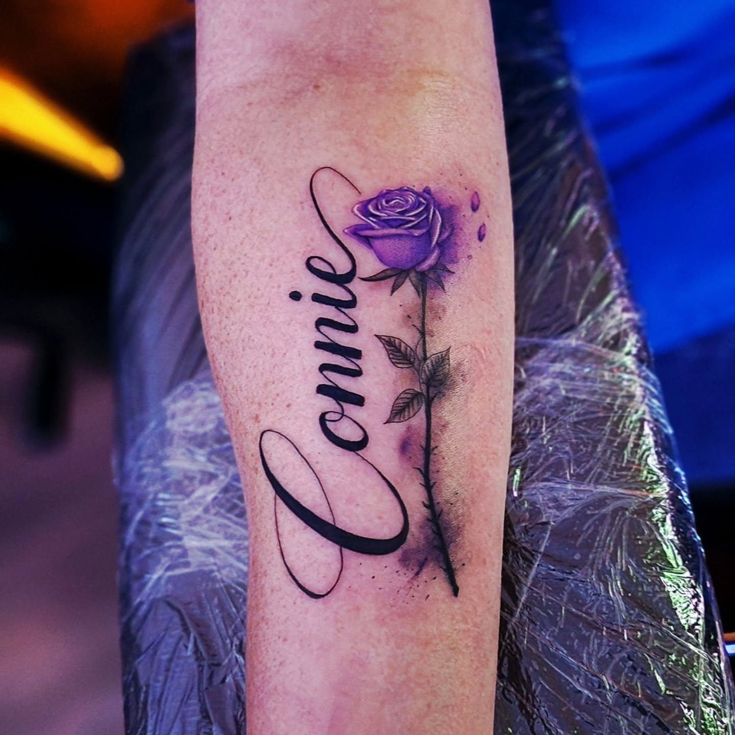 Purple rose with name realism tattoo on the forearm by Luke Jordan Ink, Louisville, Colorado