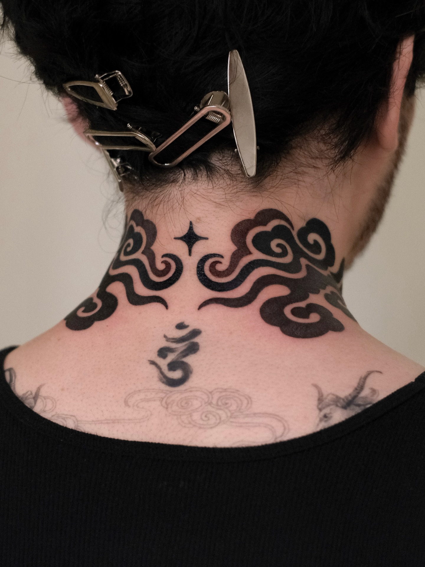 Clouds and star black and grey tattoo on the neck by seattle tattoo artist
