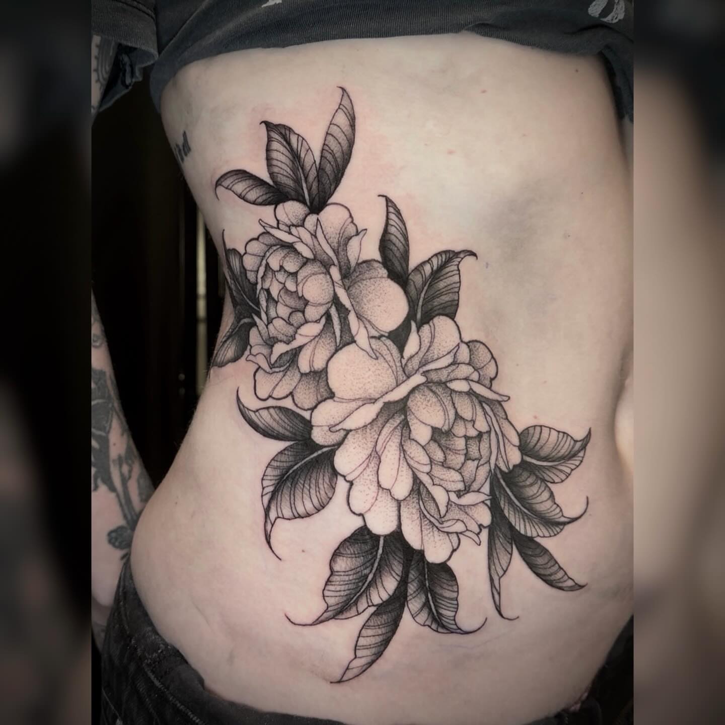Peony flowers dotwork tattoo on the ribs by Alyssa Deeghan