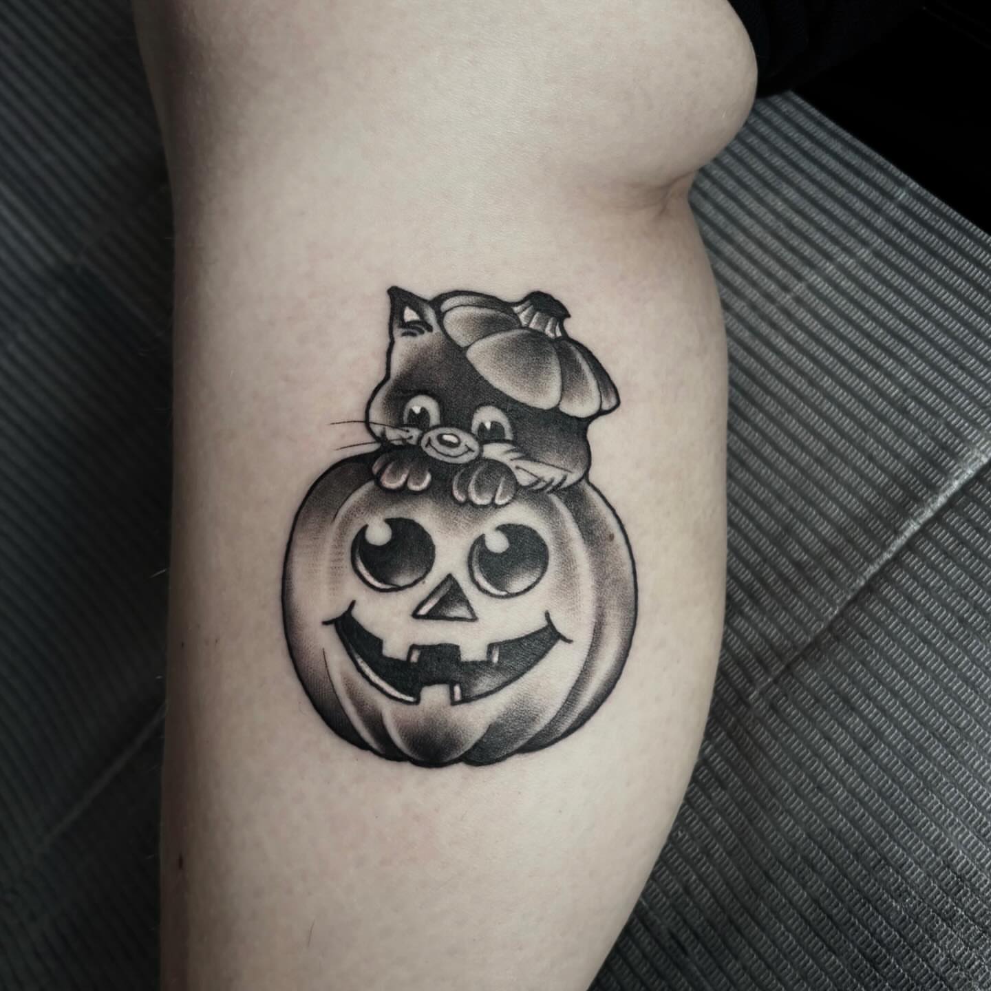 Pumpkin with cat black and grey tattoo on the forearm by Mim