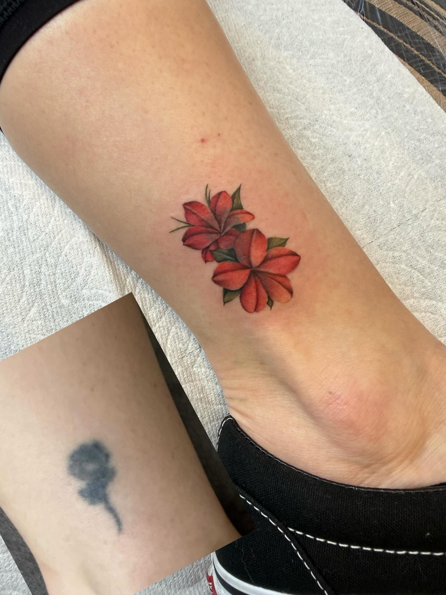 Red flowers realism tattoo on the forearm by Raytattooist