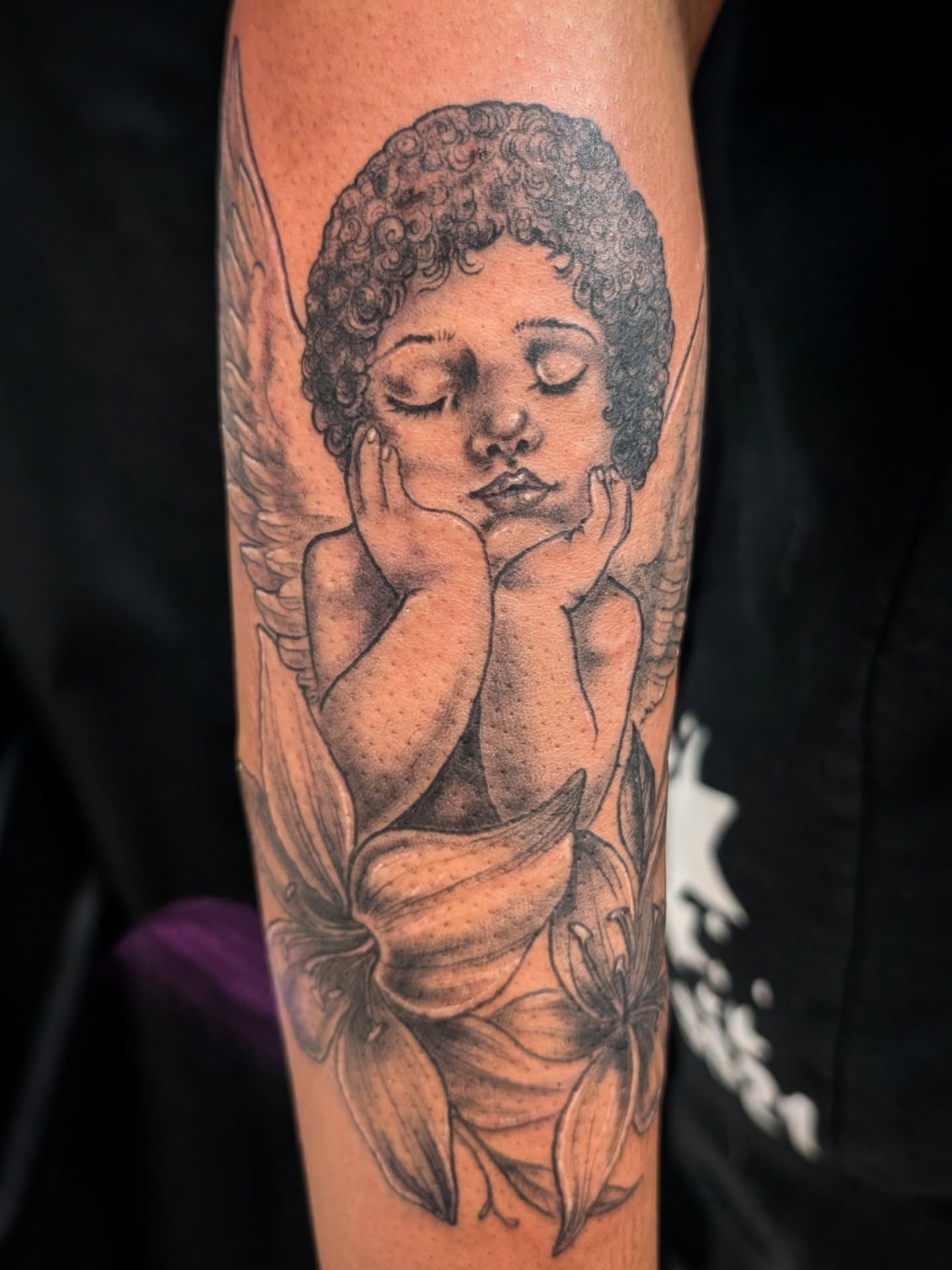 Angel with lilies realism tattoo on the forearm by Katherine