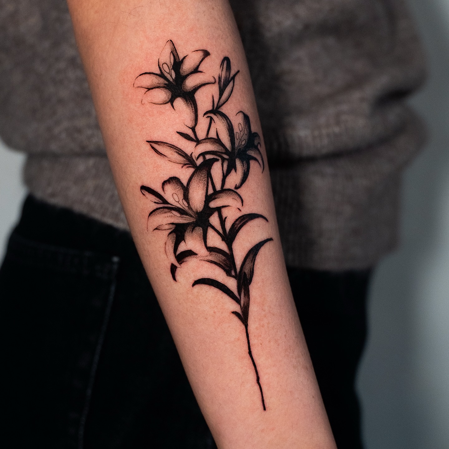 Lilies black and grey tattoo on the forearm by Kalin, Seattle, Washington