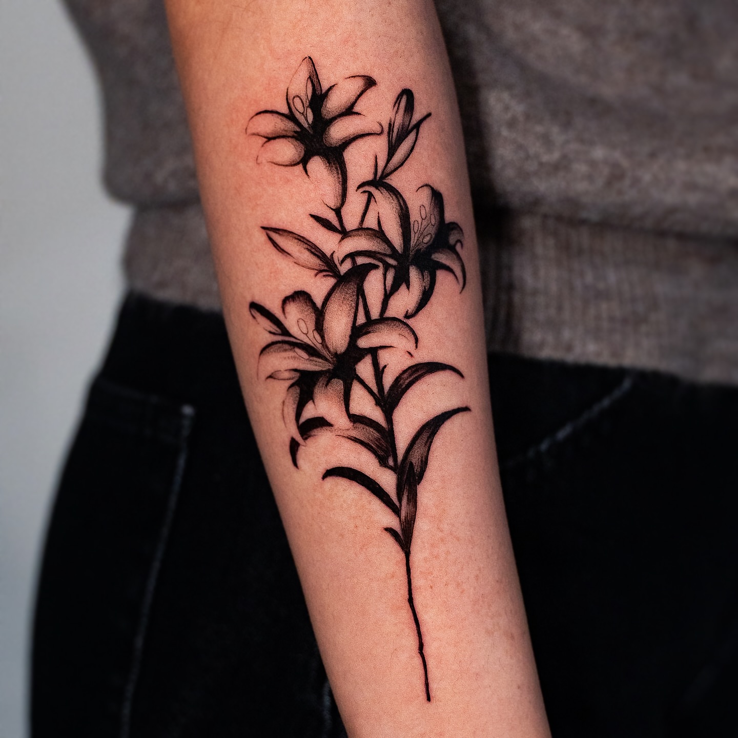 Lilies black and grey tattoo on the forearm by Kalin, Seattle, Washington