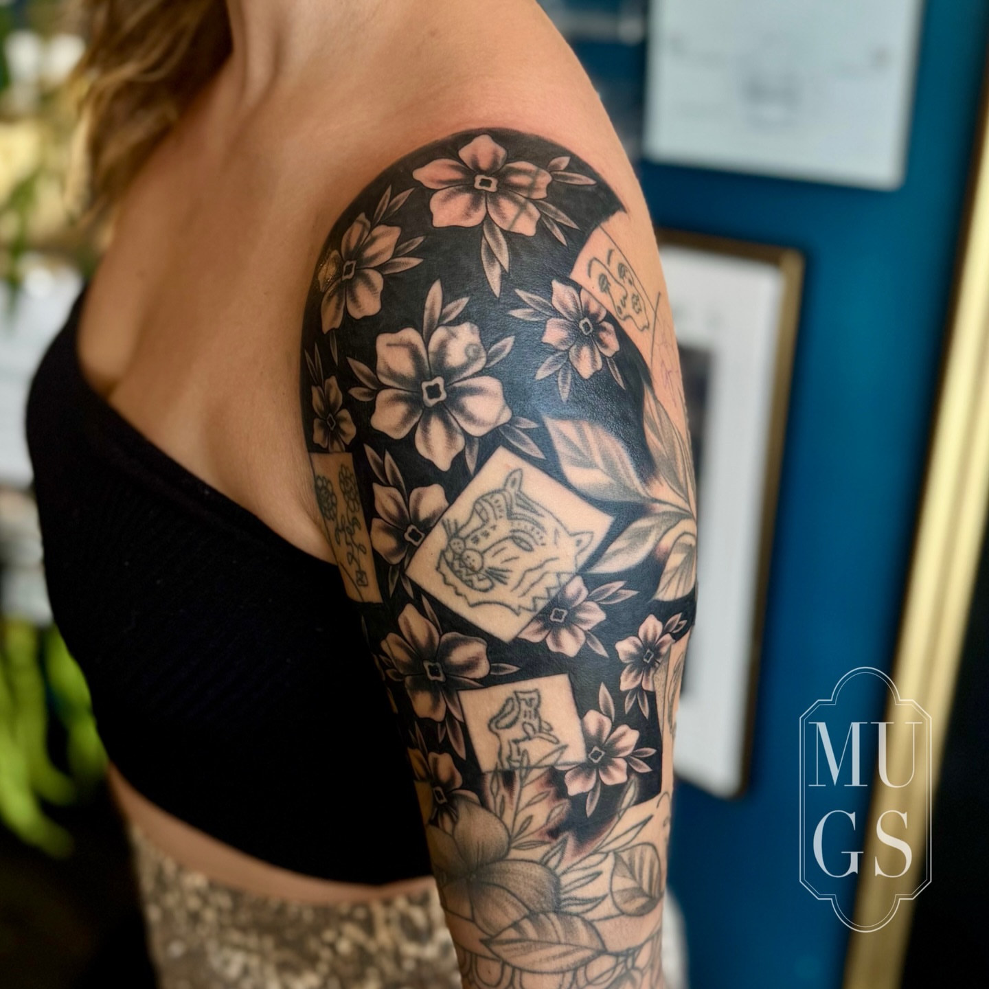 Floral and tiger American traditional tattoo on the upper arm by Emily Andreozzi