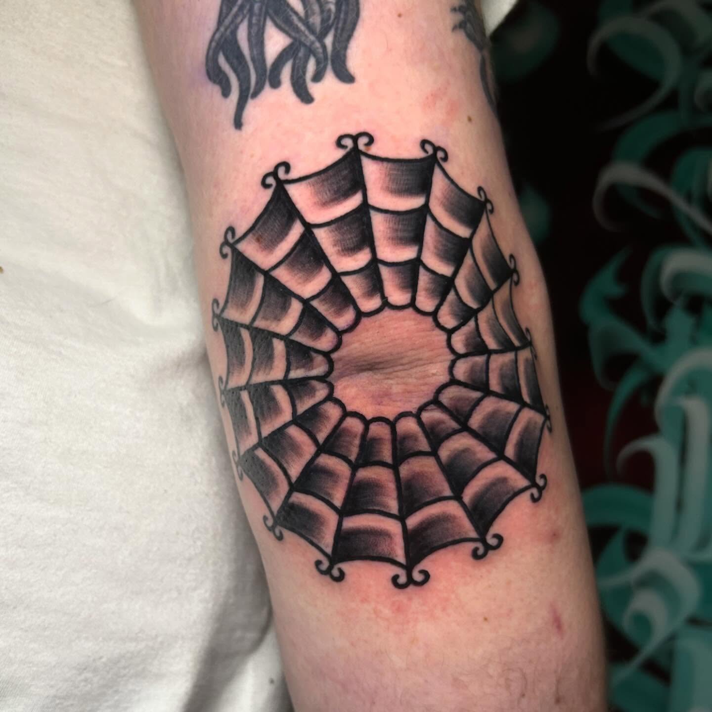 Spiderweb black and grey tattoo on the forearm by Alycia