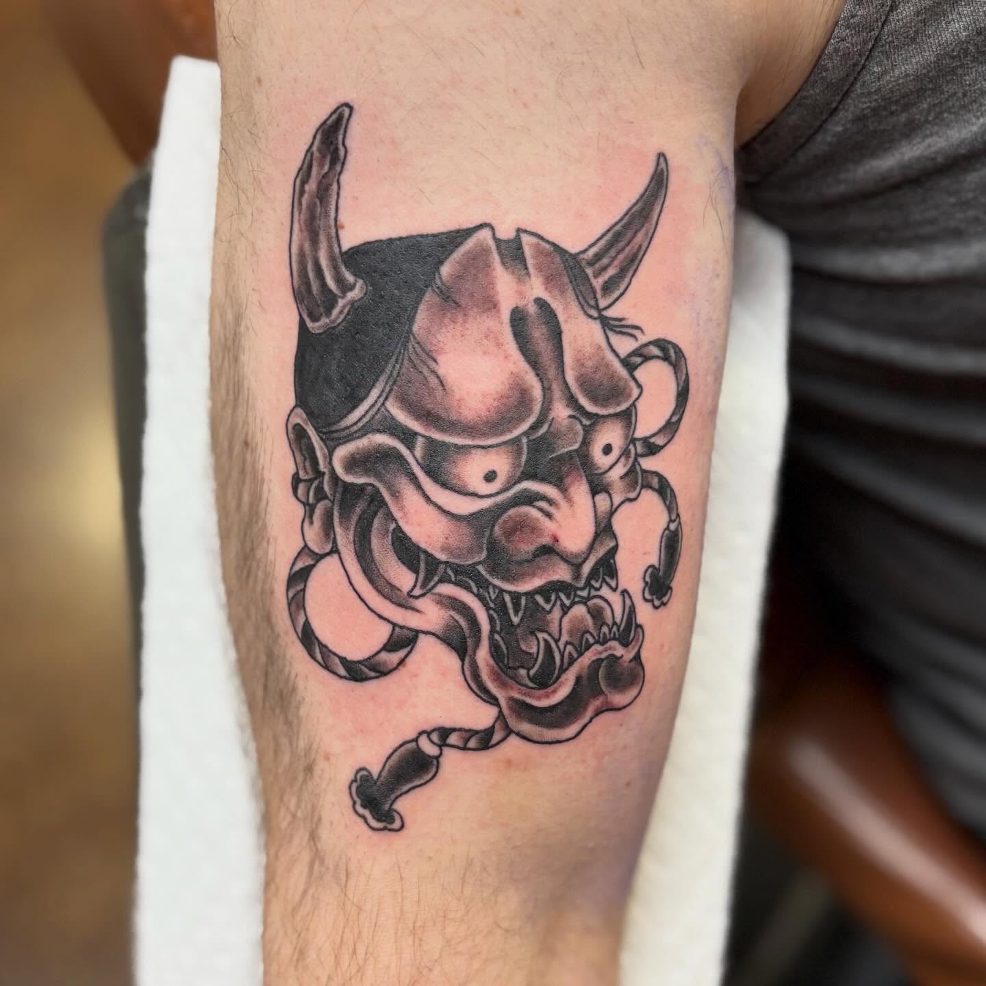 Demon mask realism tattoo on the forearm by Gabby, Kansas City, Missouri