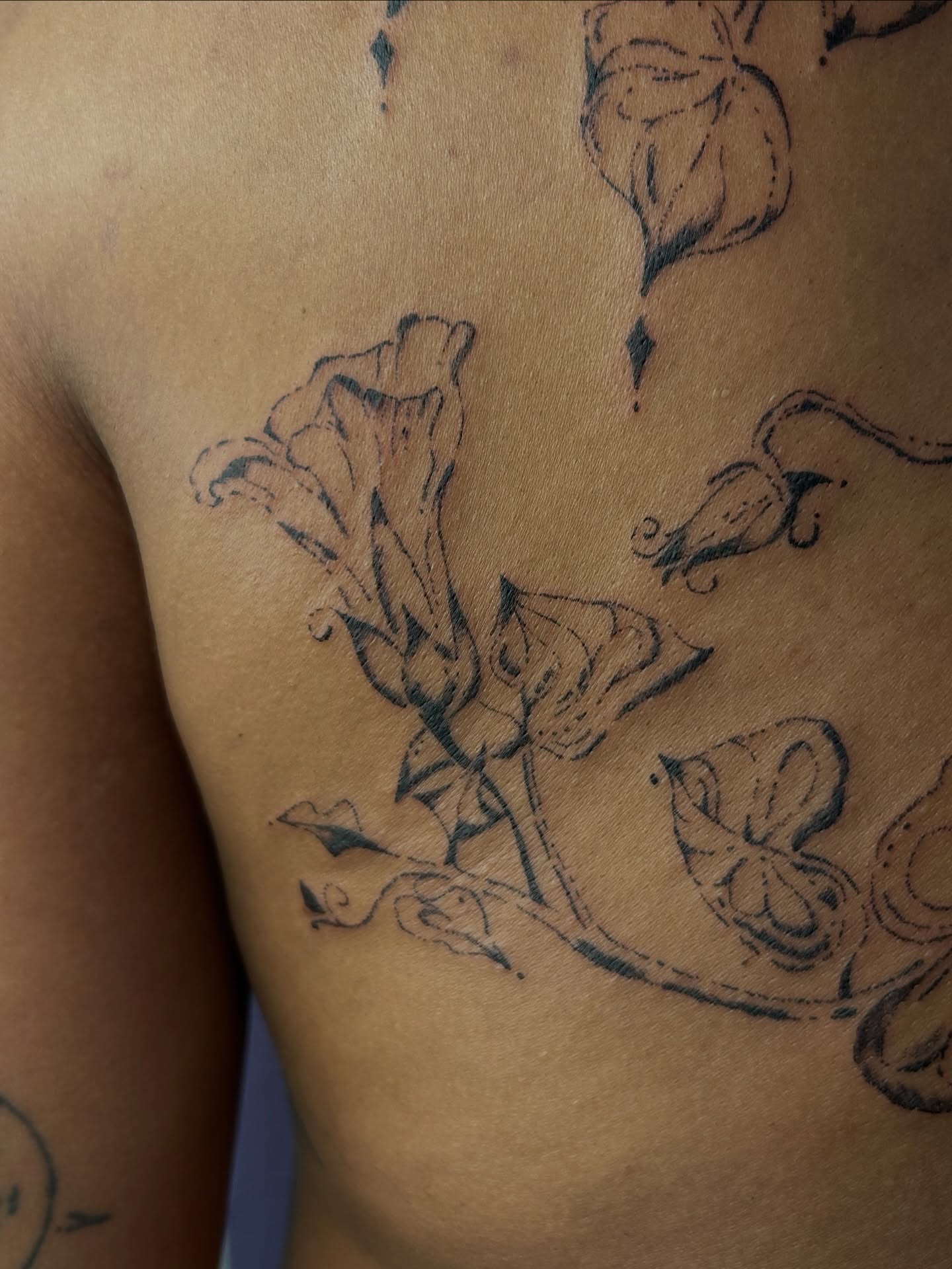 Bell-shaped flowers black and grey tattoo on the chest by wanderfernfairy