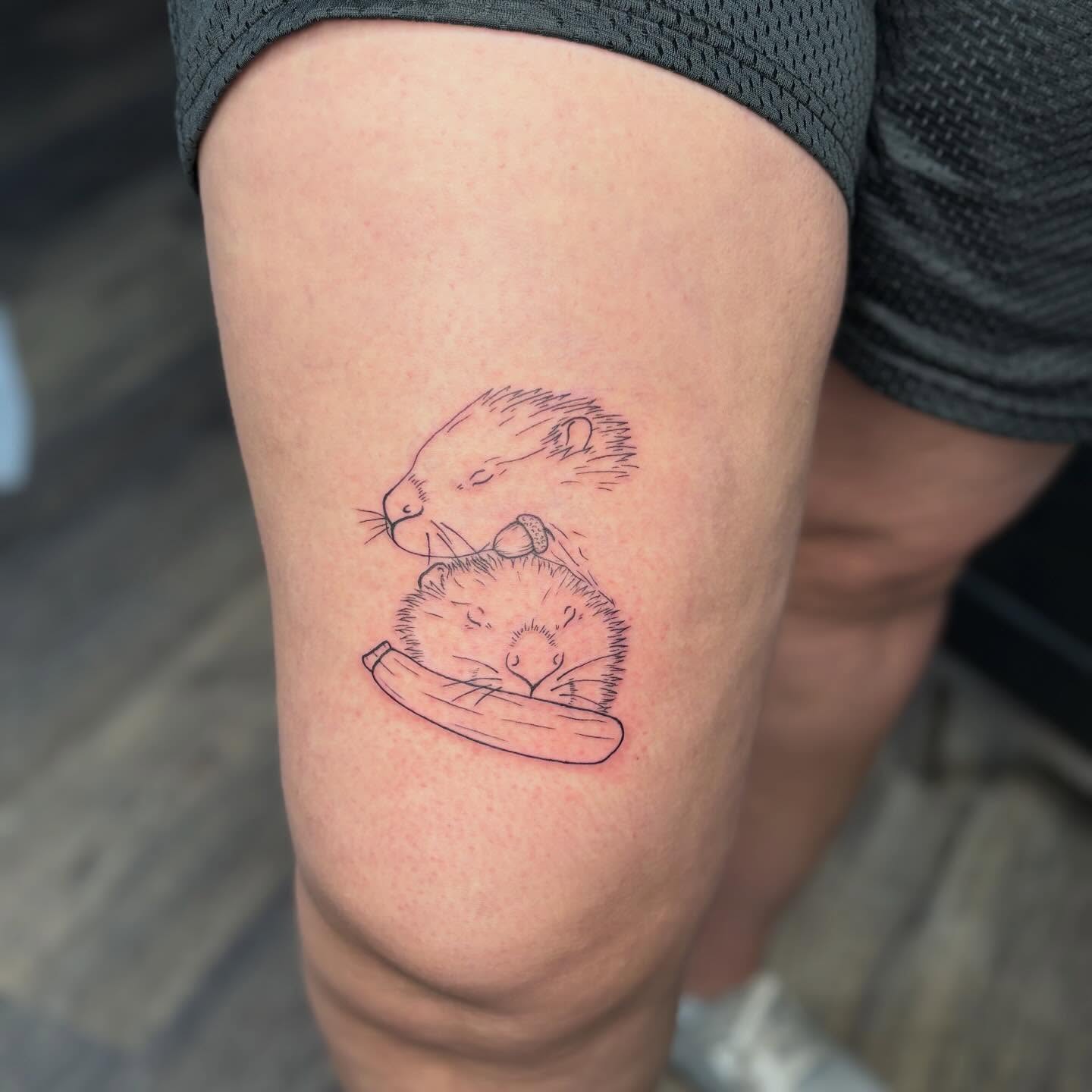 Beaver and hedgehog fine line tattoo on the thigh by Tessa Simmons - Tattoo Artist