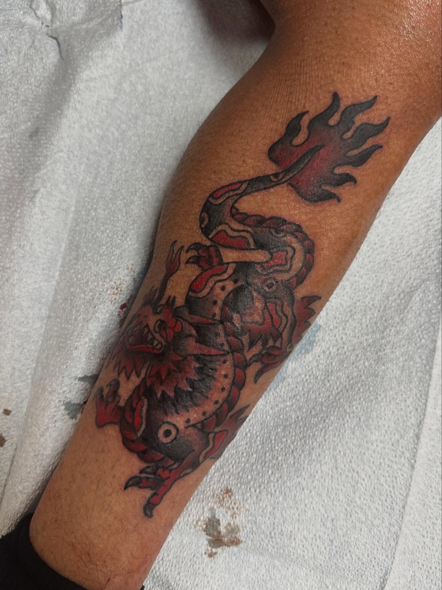 Dragon American traditional tattoo on the forearm by norawillstattoo