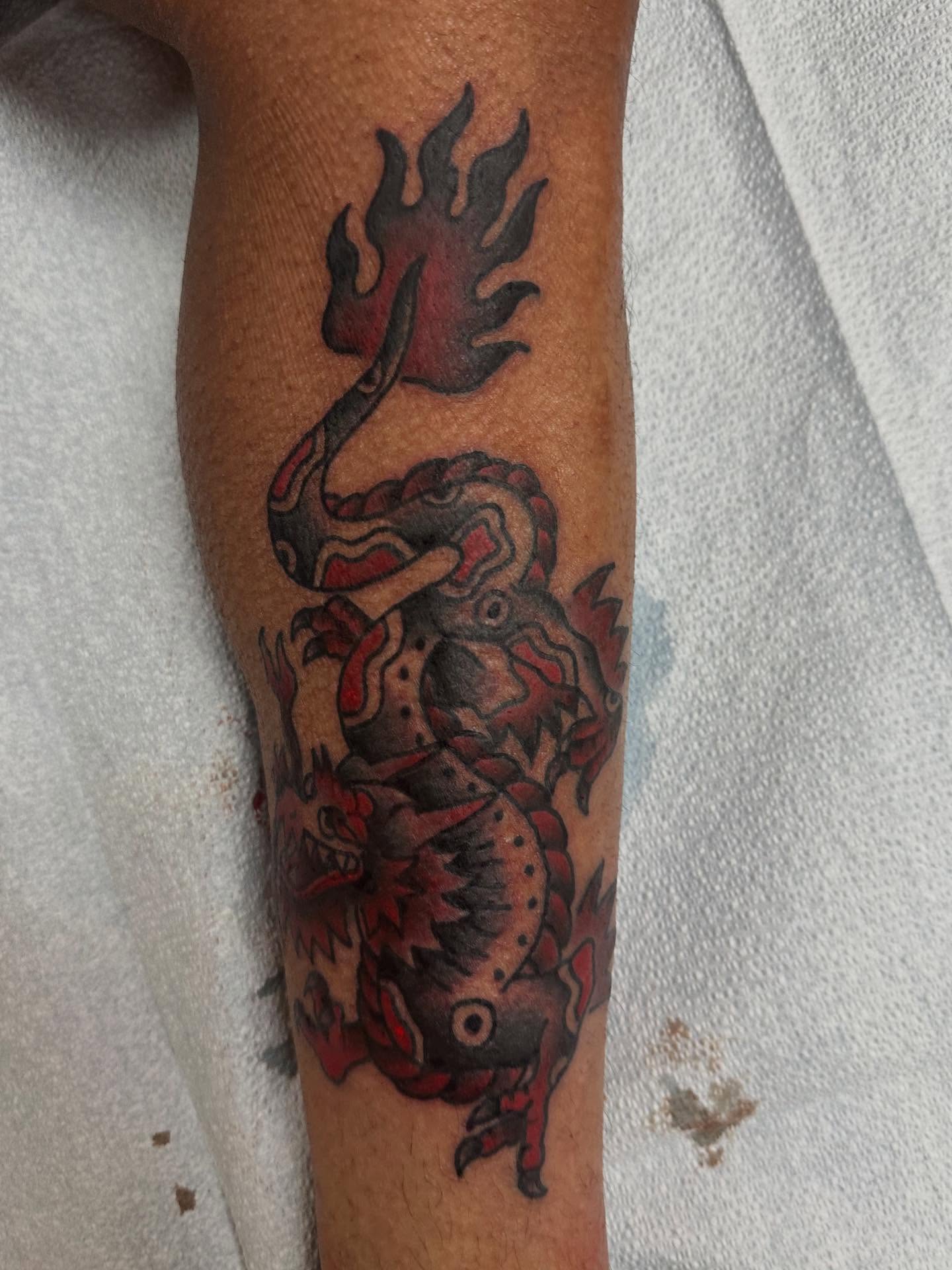 Dragon American traditional tattoo on the forearm by norawillstattoo