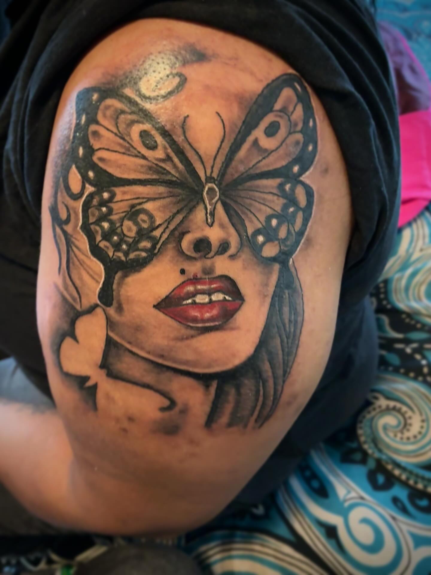 Woman with butterfly realism tattoo on the shoulder by Sonya son tattoos and piercings