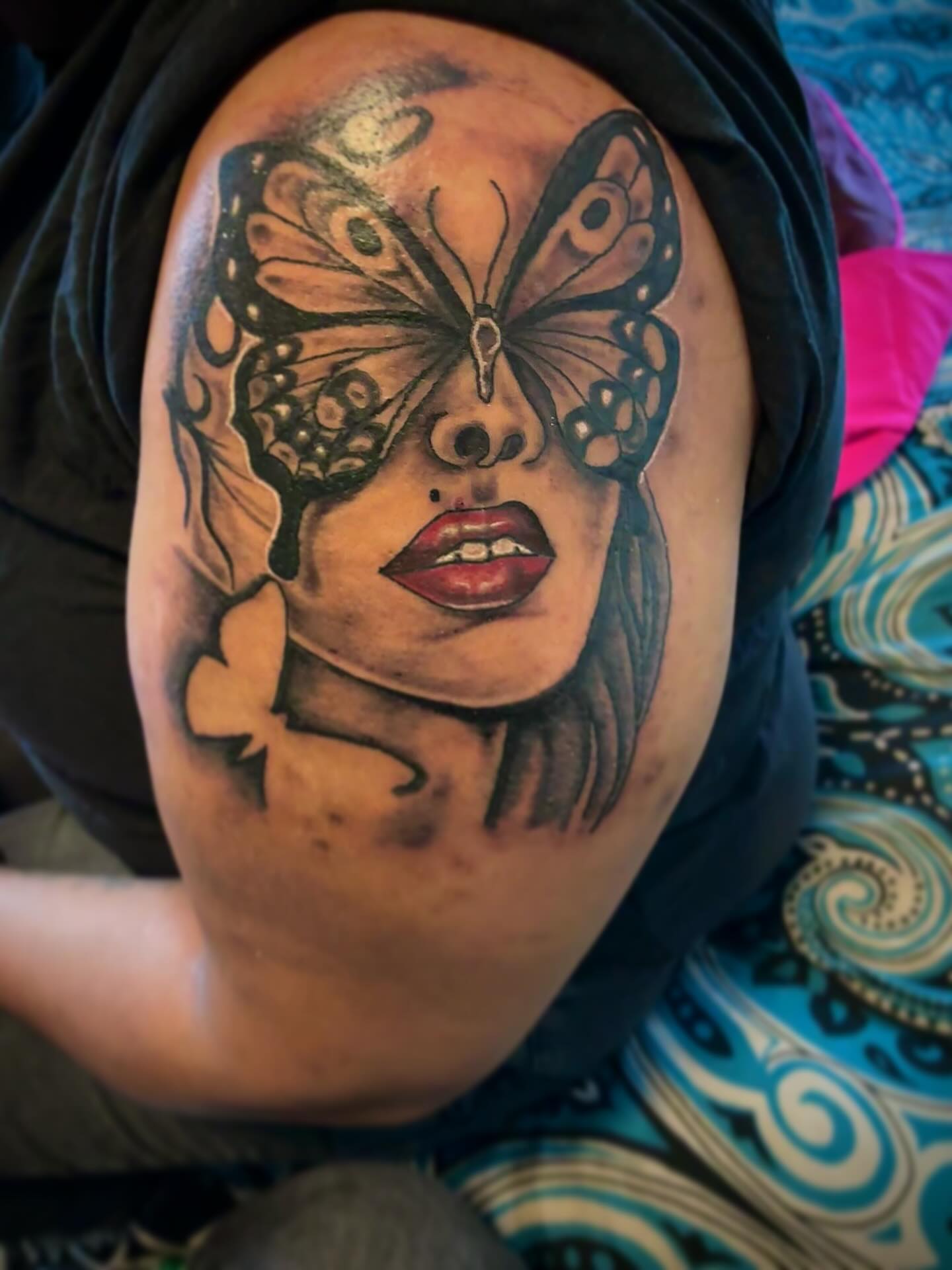 Woman with butterfly realism tattoo on the shoulder by Sonya son tattoos and piercings
