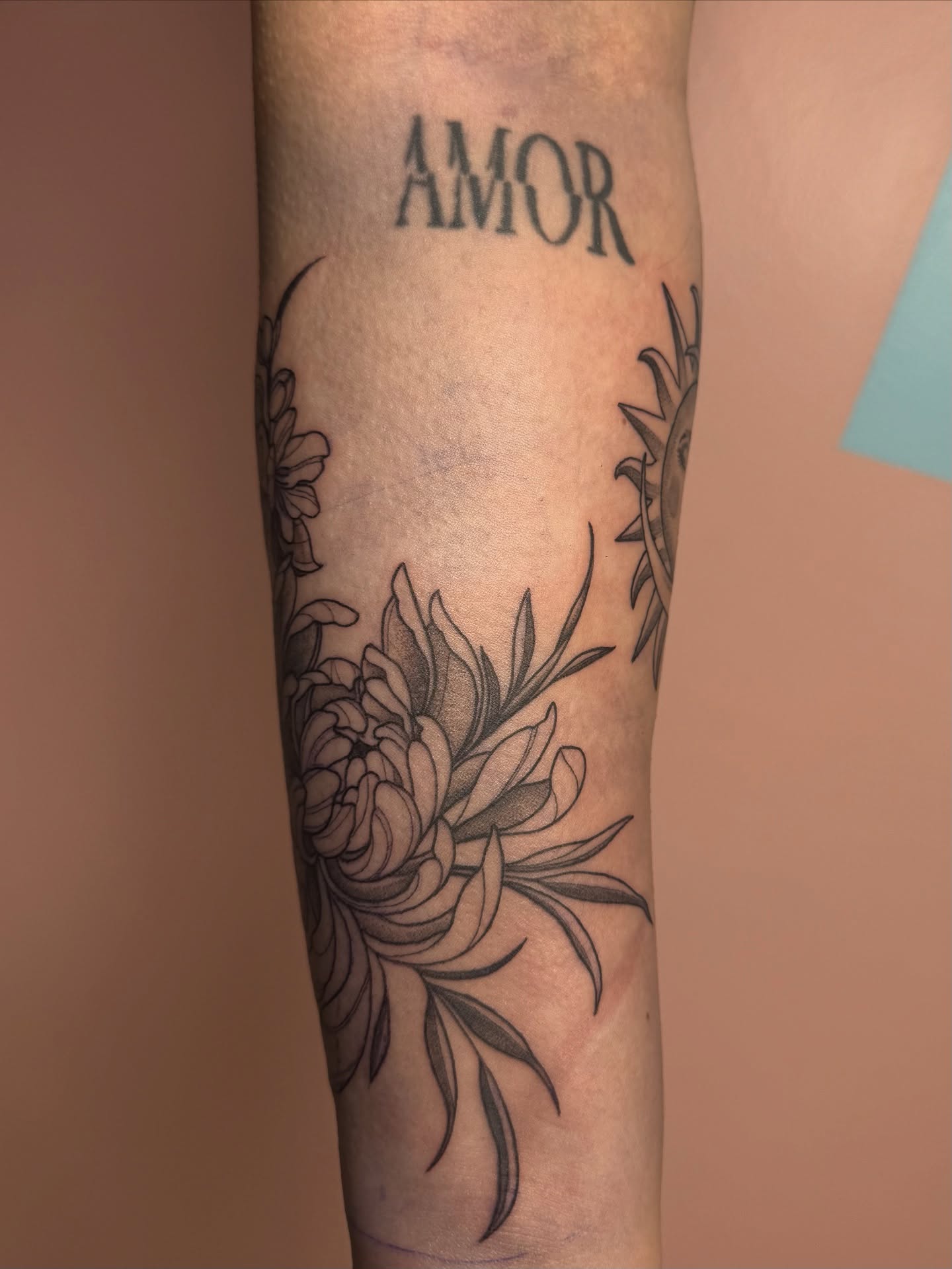 Peony and floral wreath black and grey tattoo on the forearm by Eva, Matawan, New Jersey
