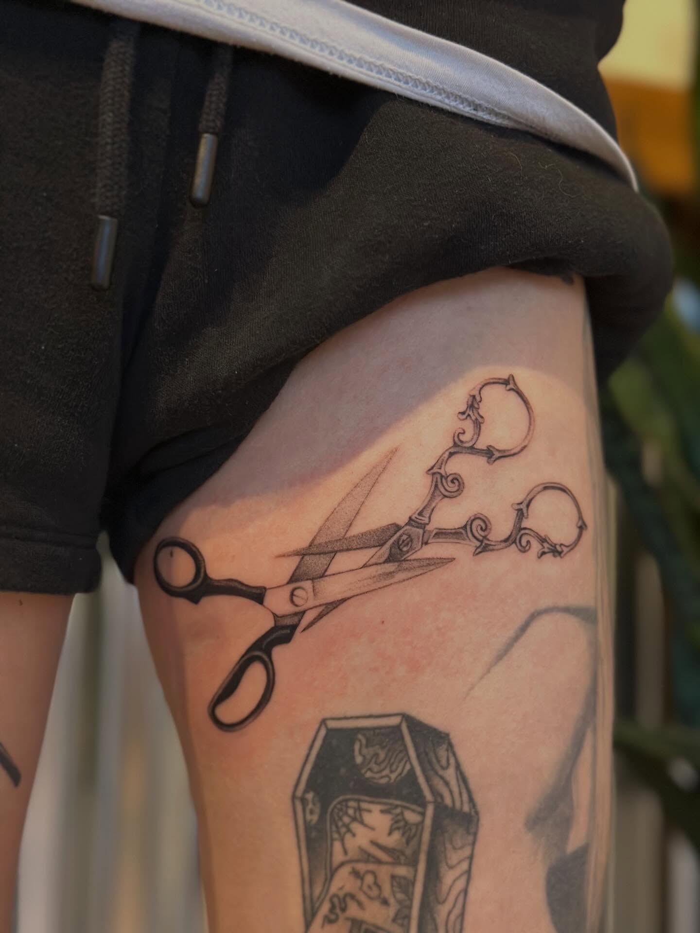 Scissors black and grey tattoo on the thigh by sara scak, Lakewood, Ohio