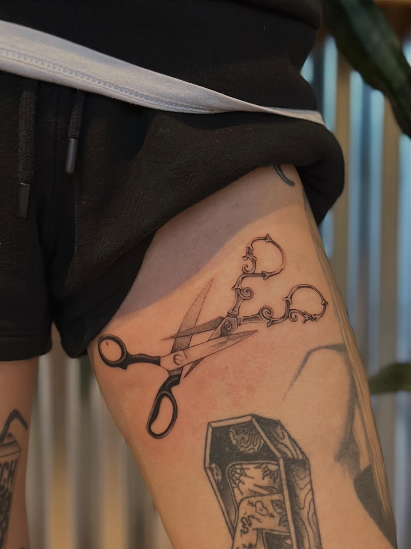 Scissors black and grey tattoo on the thigh by sara scak, Lakewood, Ohio