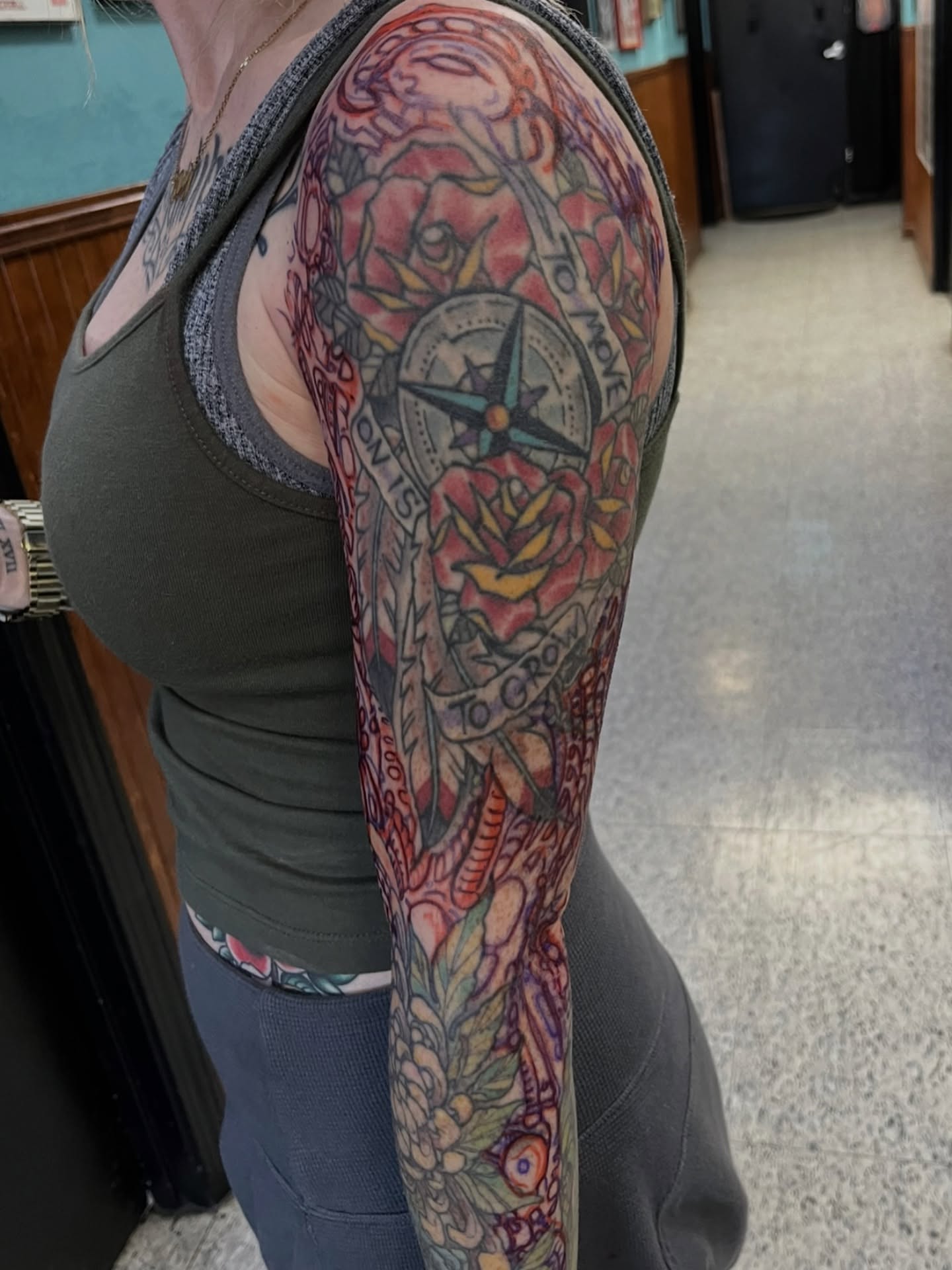 Compass and roses American traditional tattoo on the upper arm by Andrew Snowden