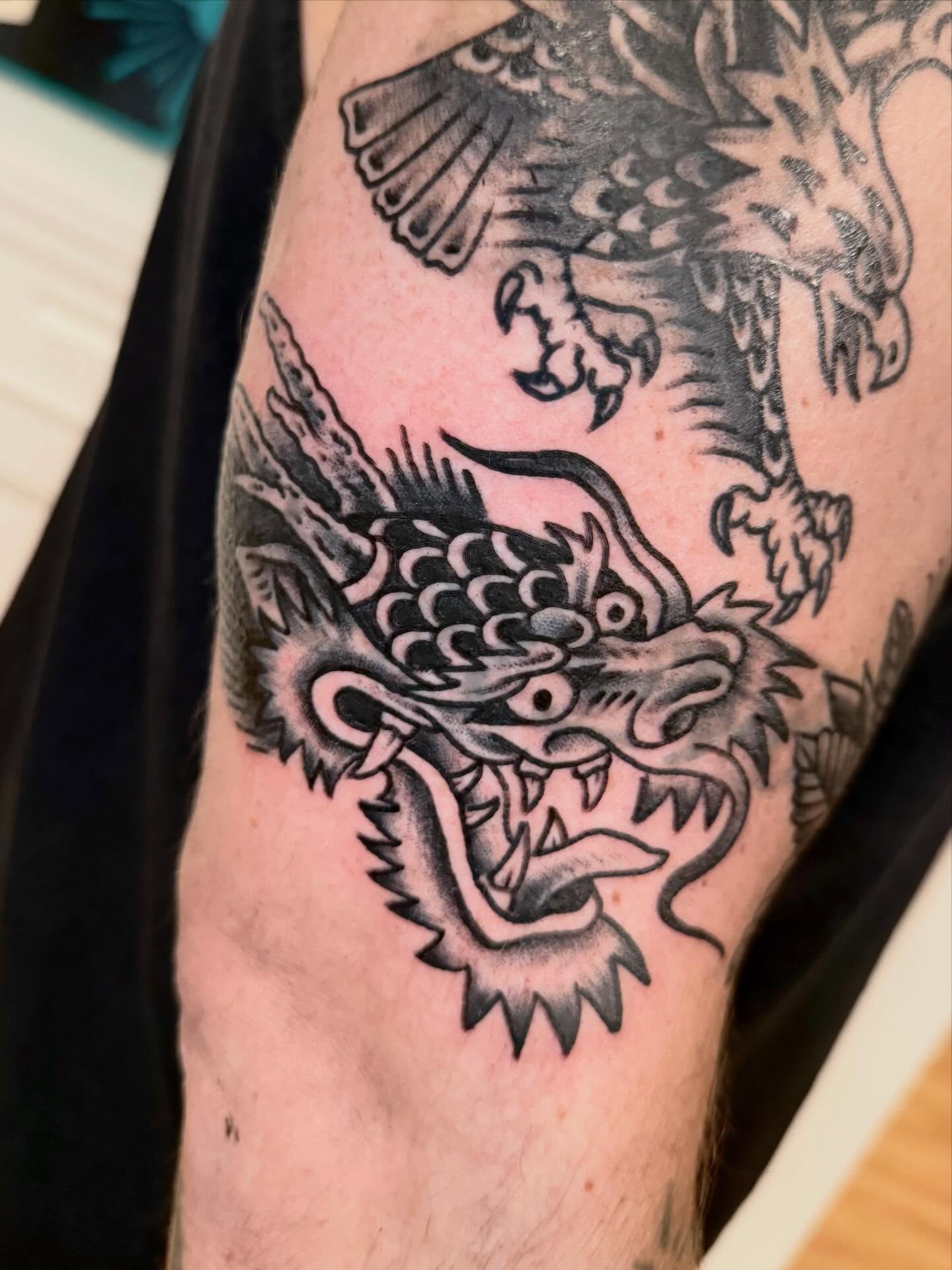 Dragon black and grey tattoo on the forearm by Jesse Boss, Nashville, Tennessee