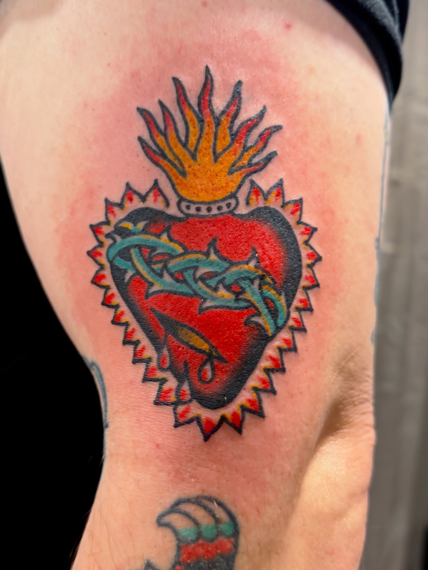 Heart with flames and dragon American traditional tattoo on the thigh by Jimmy Kelley