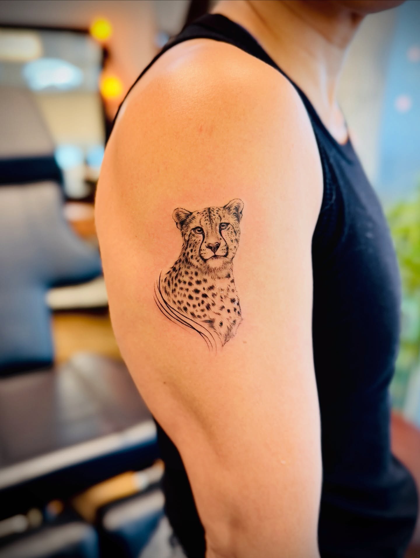 Cheetah realism tattoo on the upper arm by Aristova Anastasia