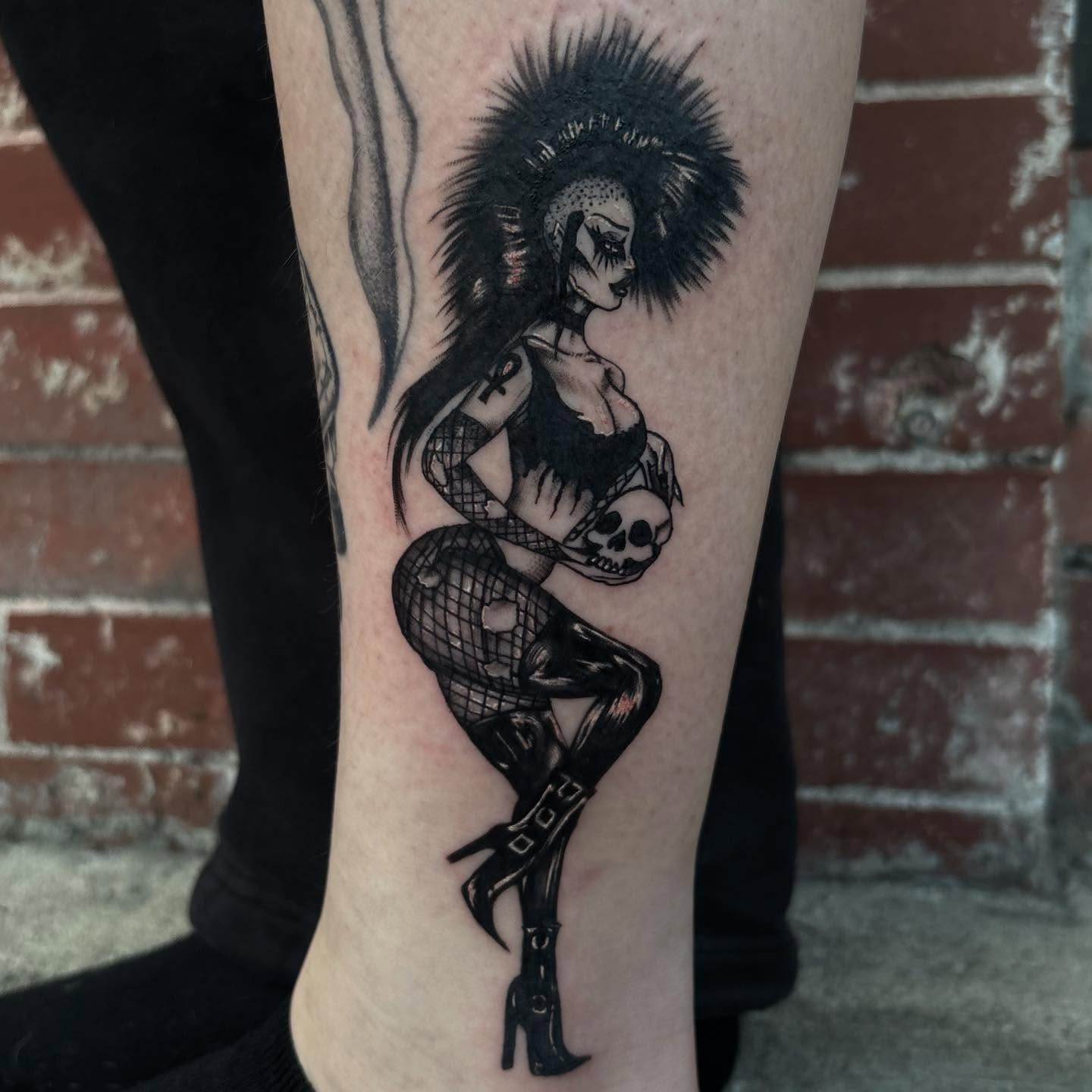 Pin-up girl with skull realism tattoo on the forearm by 𝕶𝕬𝕿