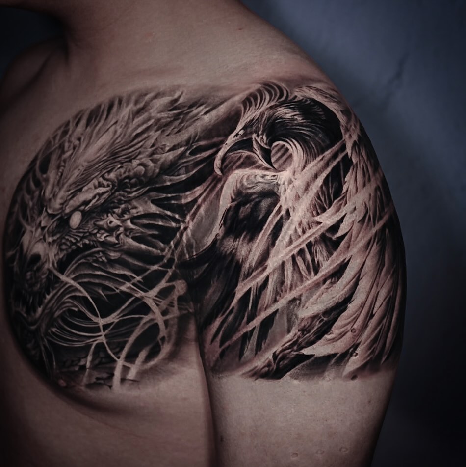 Dragon and phoenix biomech tattoo on the shoulder by Pitasso tattoo black and grey