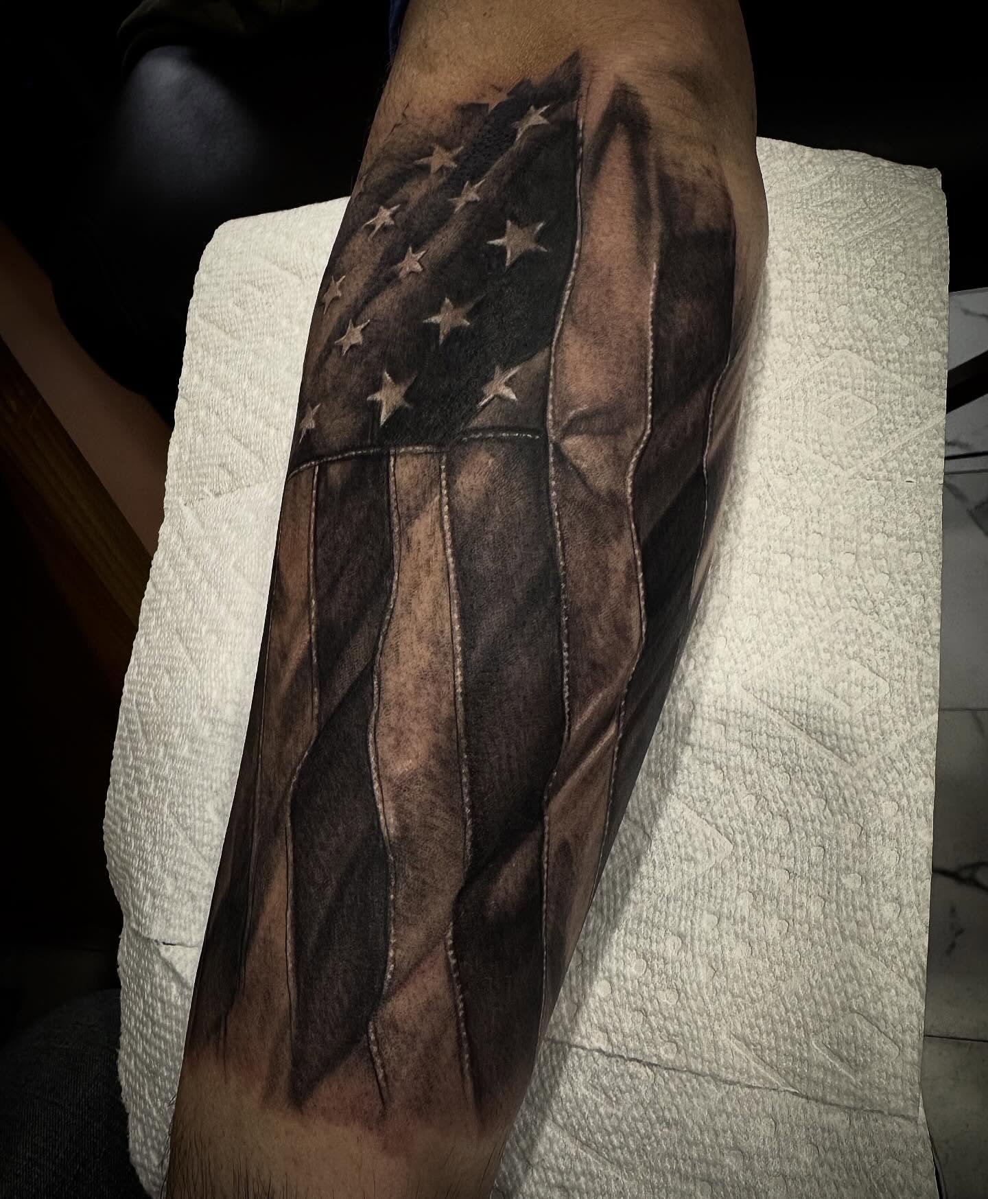 American flag realism tattoo on the forearm by Keith Smith