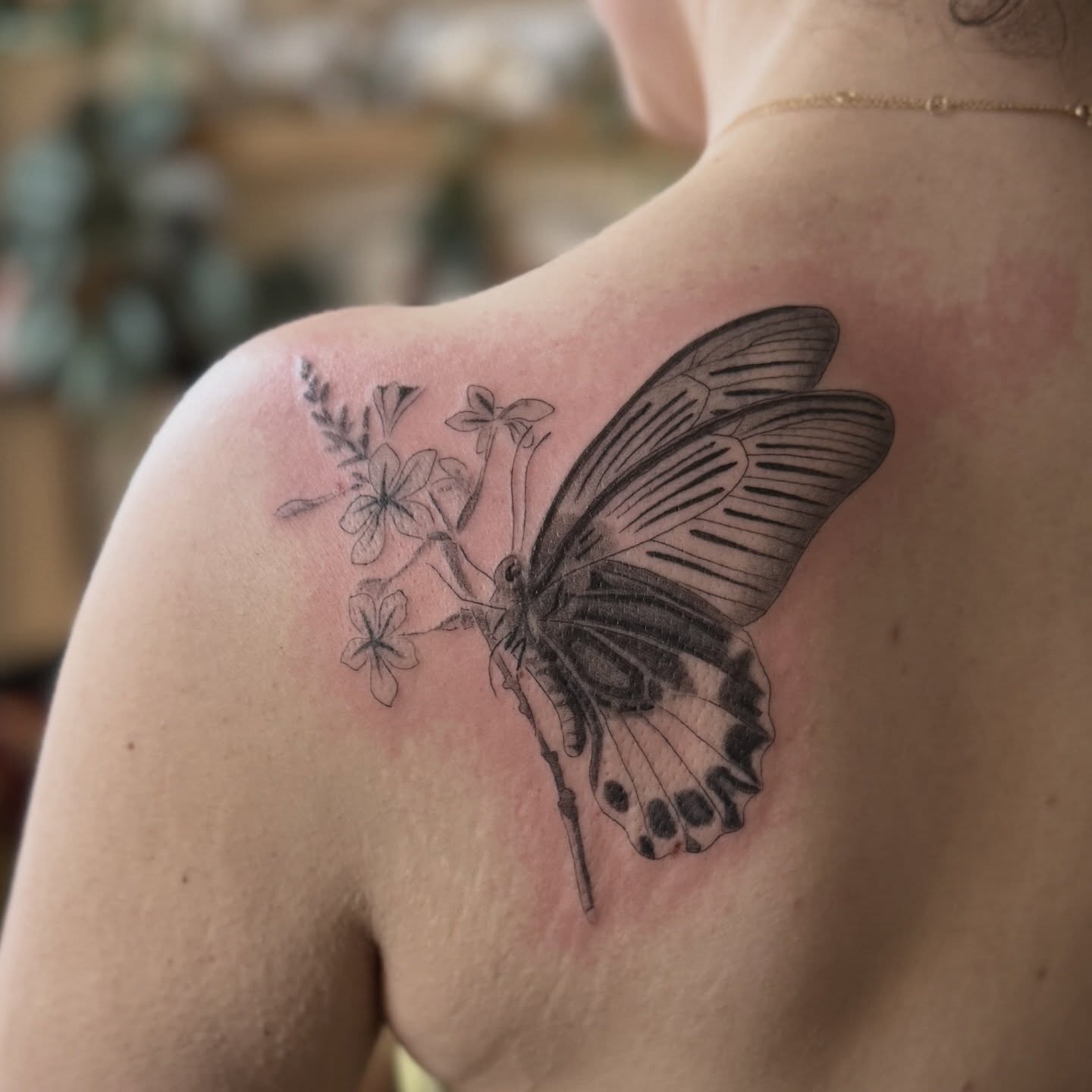Butterfly and flowers realism tattoo on the shoulder by Leah - Tattoo Artist