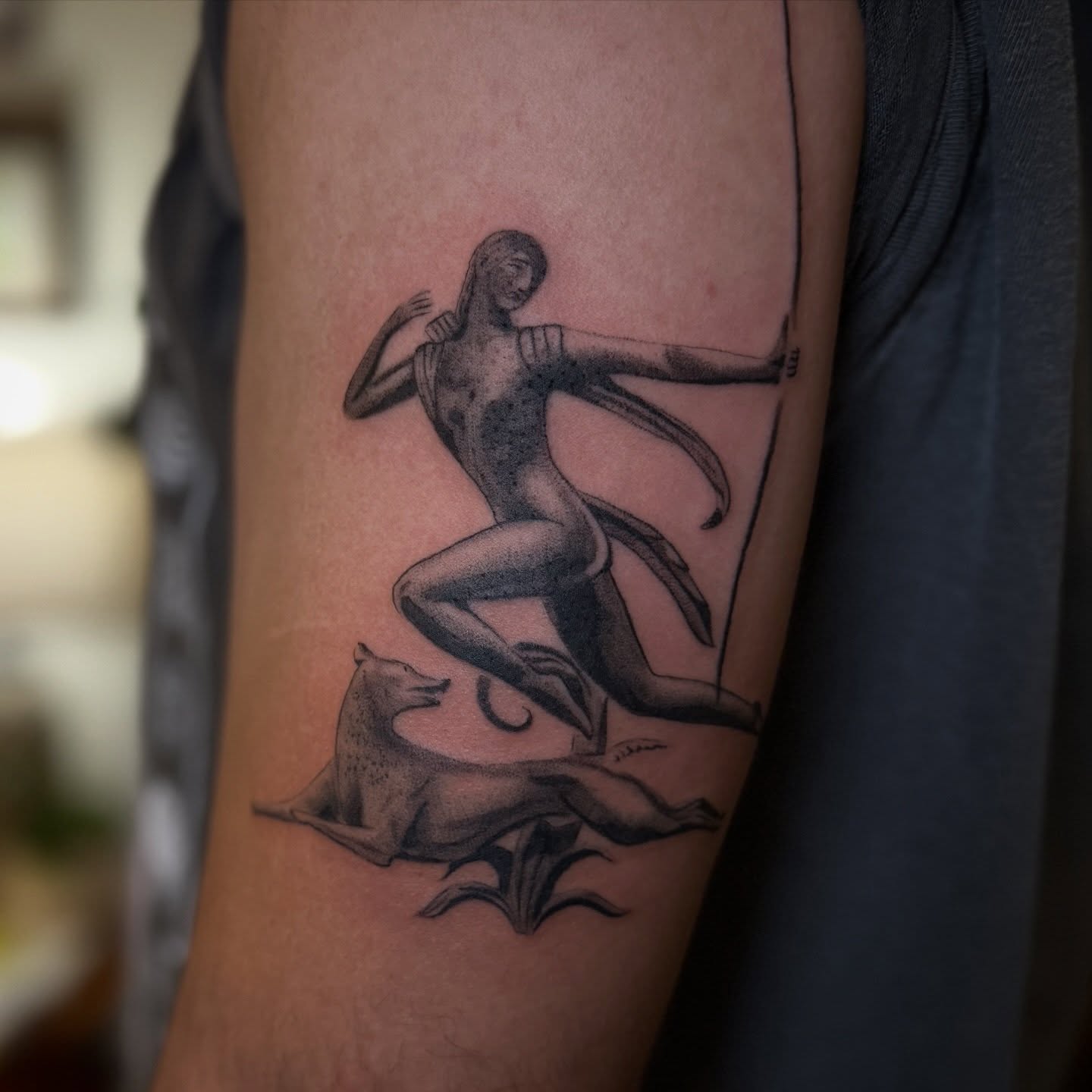 Archer black and grey tattoo on the forearm by Leah - Tattoo Artist